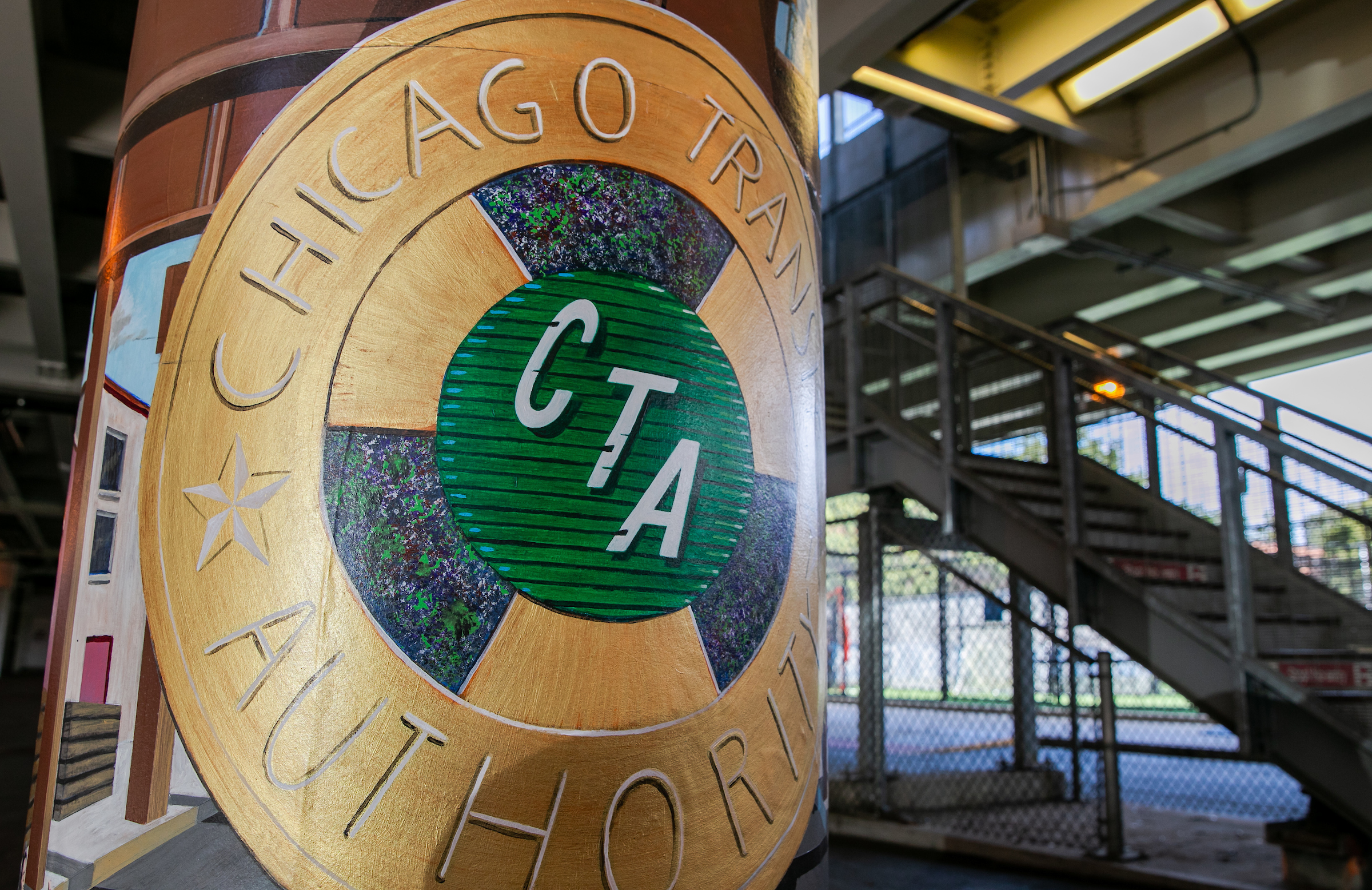 A painted pillar sports a mural with the Chicago Transit Authority logo
