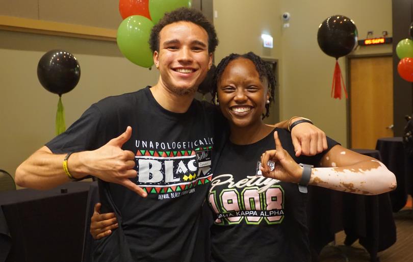 Two people posing for a picture at an event at the Black Cultural Center.
