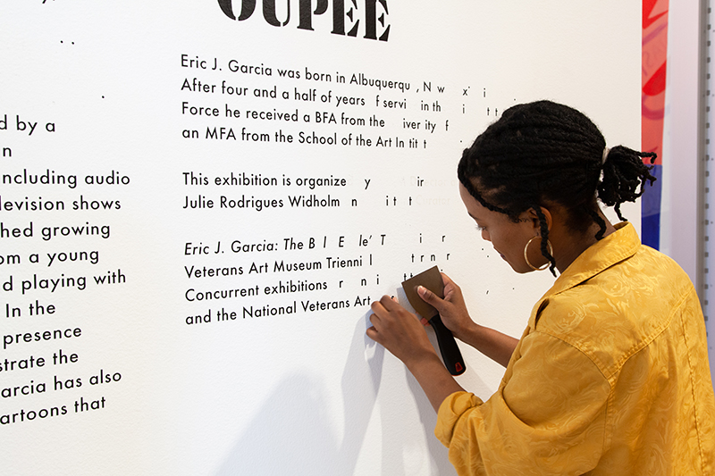 Former fellow Kacey removes vinyl wall text after an exhibit