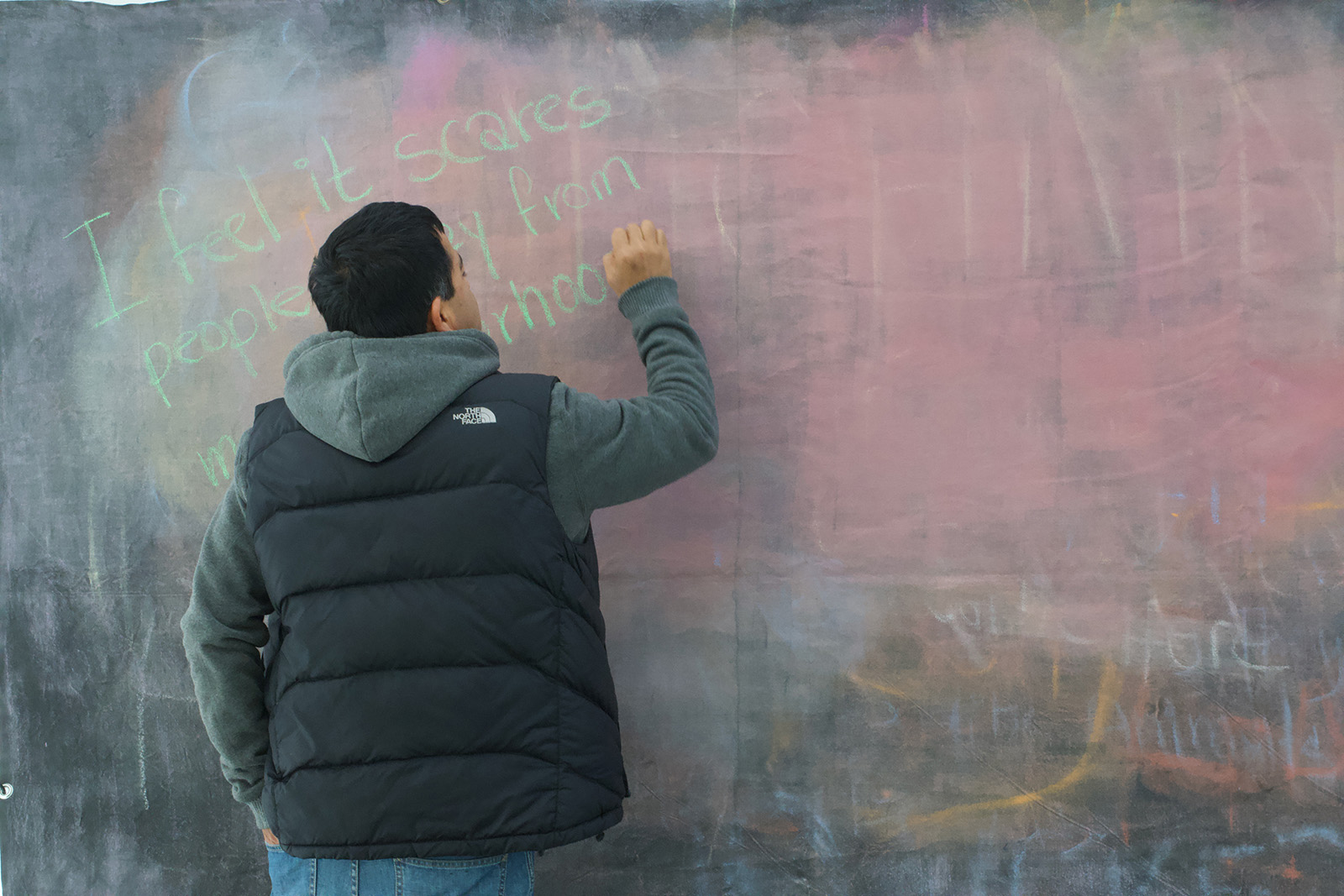 Boy writing on chalkboard