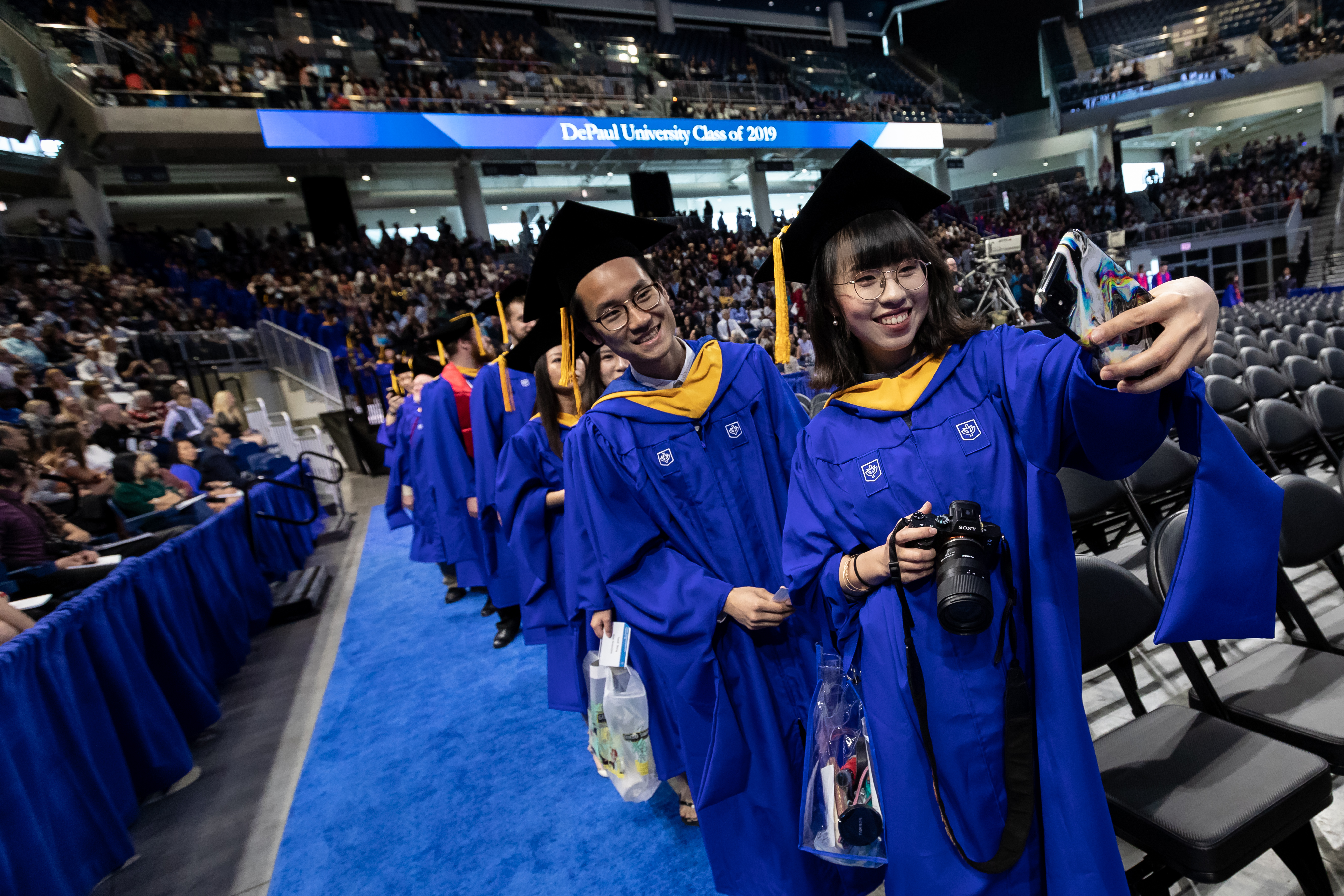 Students take a selfie before their graduation ceremony 