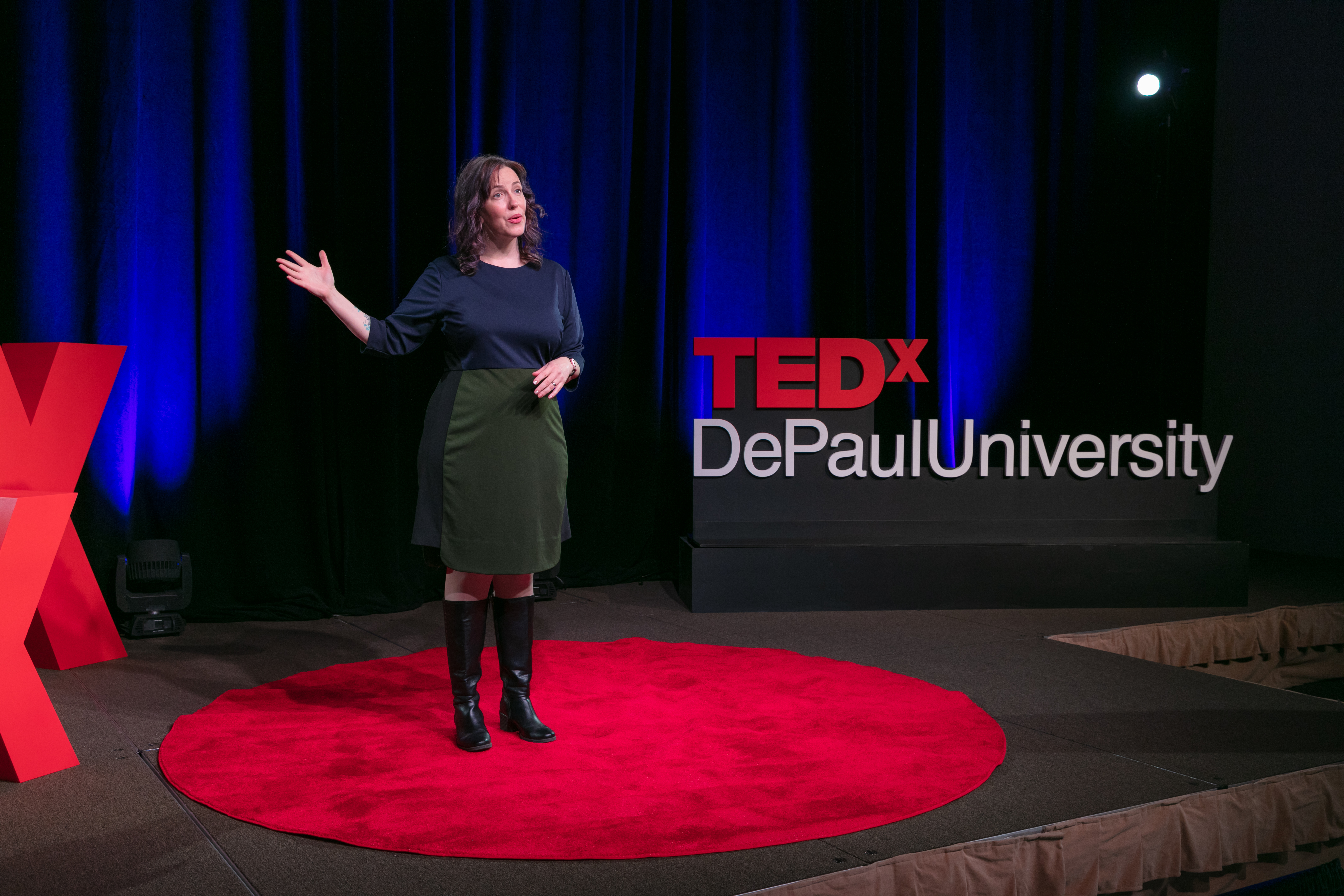Coya Paz stands on stage giving her TEDxDePaulUniversity Talk