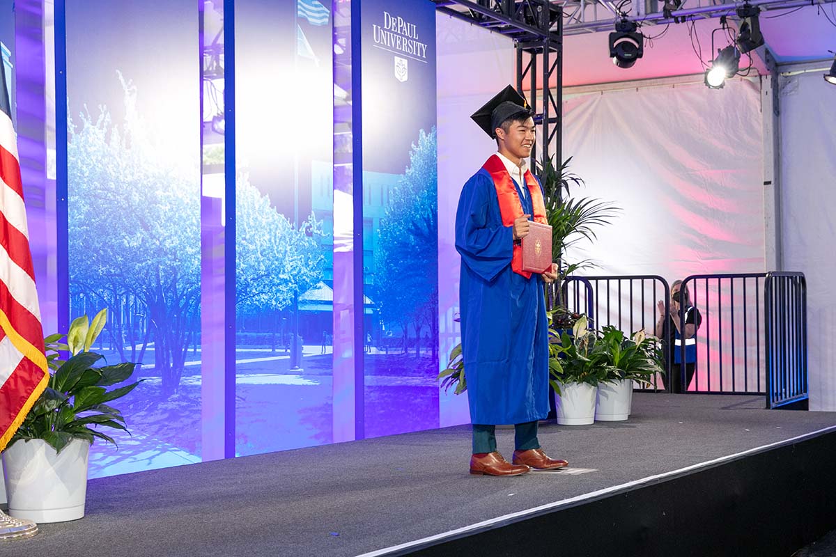Student walks across graduation stage