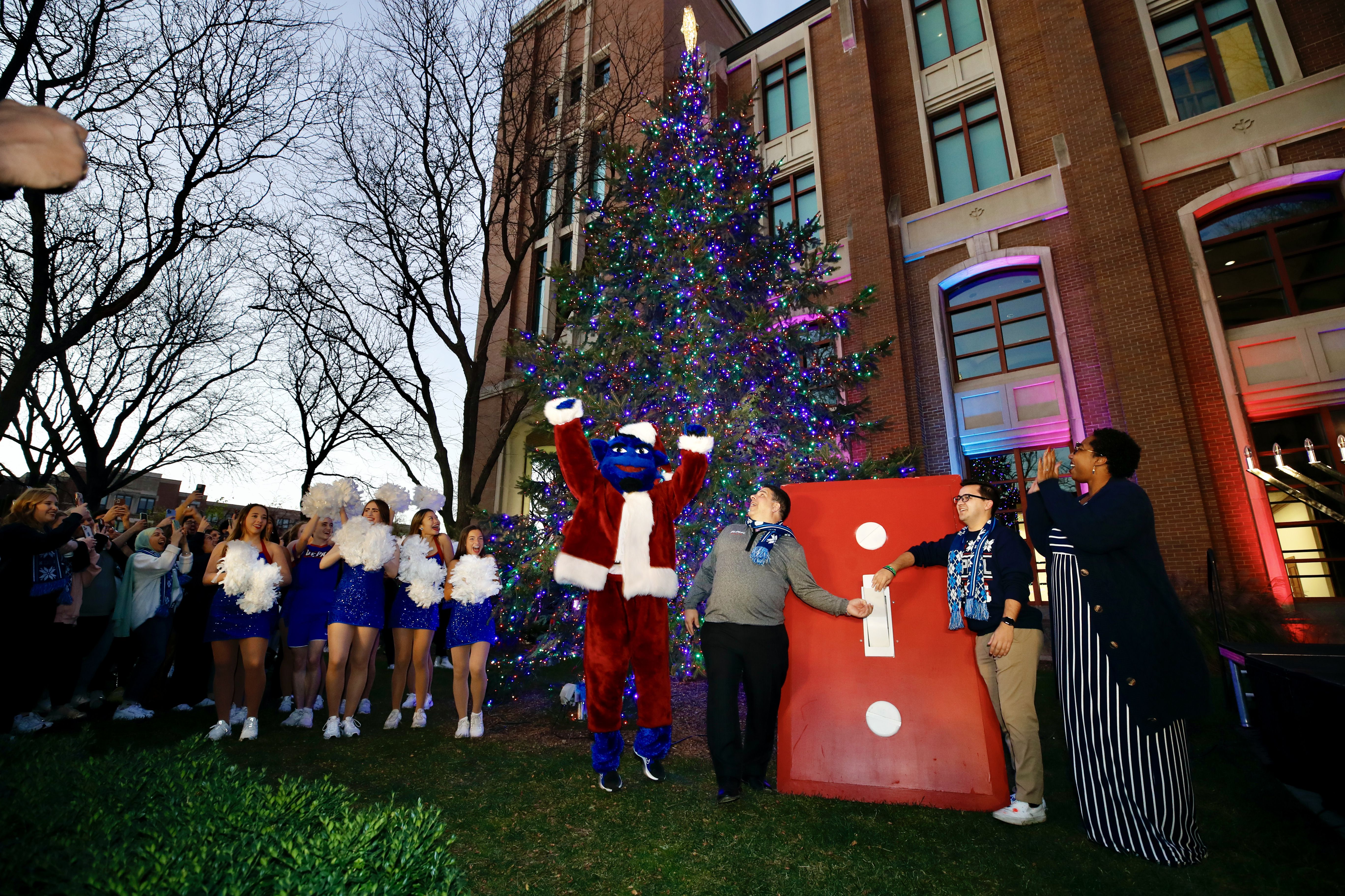 As the sun began to set, DIBS, Manuel and Kevin Holechko, president of Student Government Association, flipped the switch to light DePaul's Holiday Tree. The tree will remain lit through the December intersession. (
