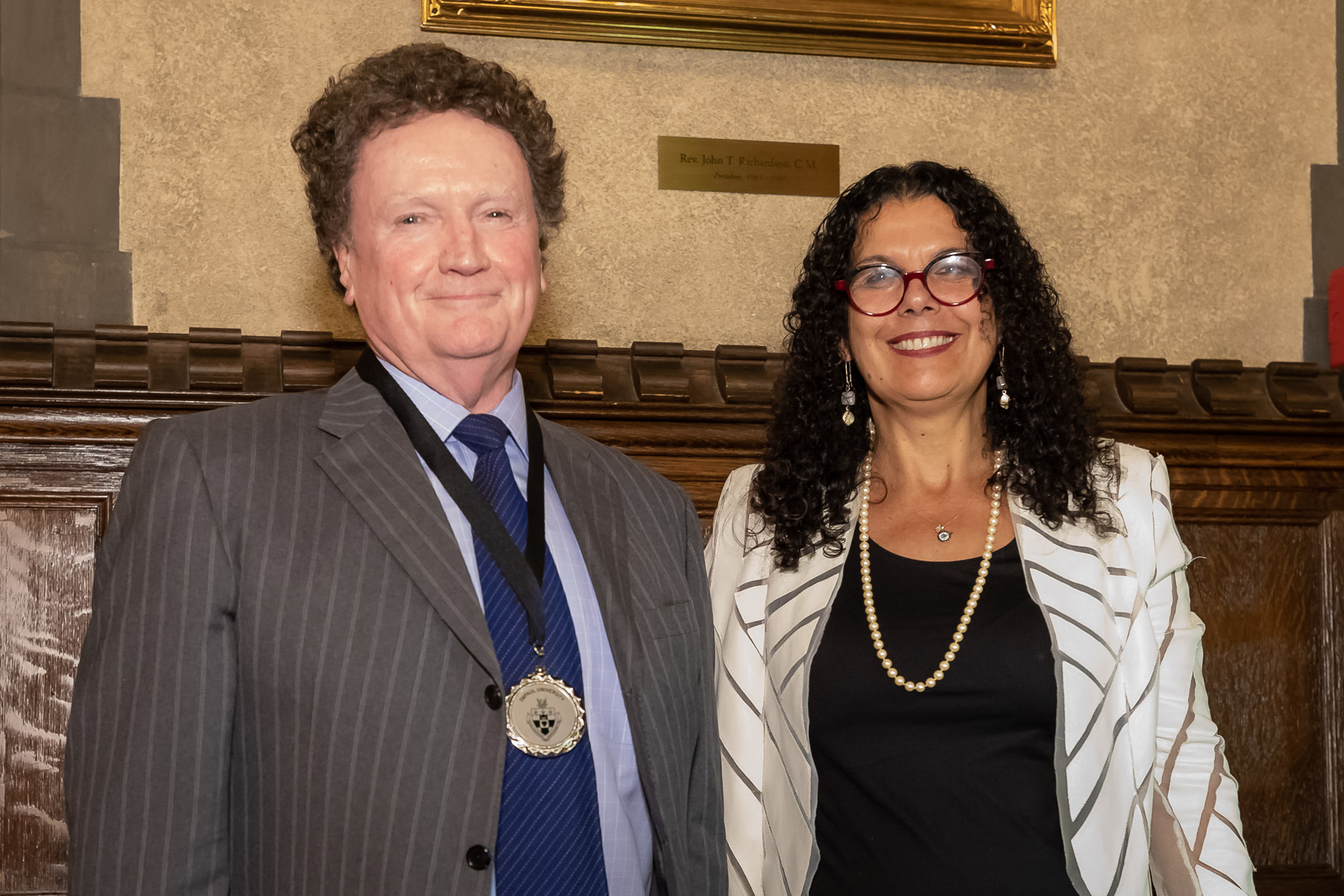 Geoffrey Wiseman, with Provost Salma Ghanem, wears the medal that symbolizes his endowed chair position.