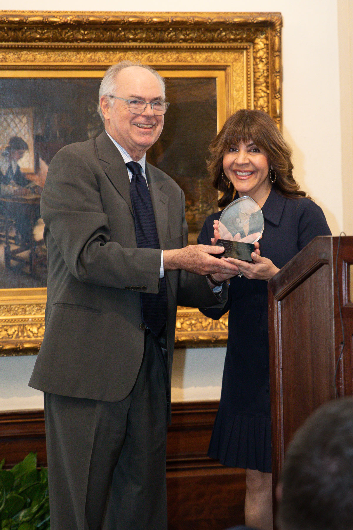 Alumna Sally Ramirez accepts the 2023 Distinguished Alumni award from Center Co-Director Don Moseley. (Photo by Sandy Rosencrans)