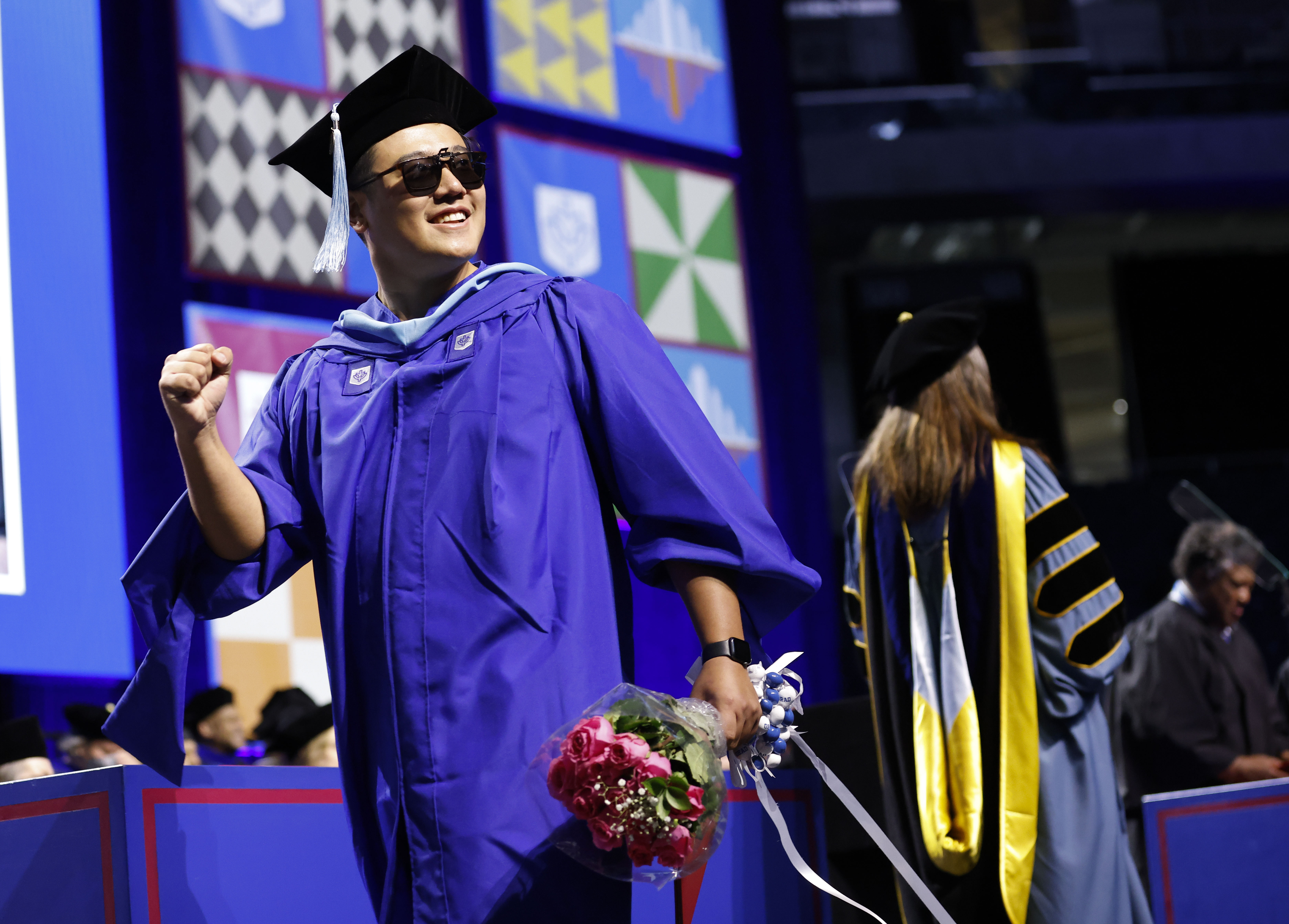 A man in sunglasses crosses the stage