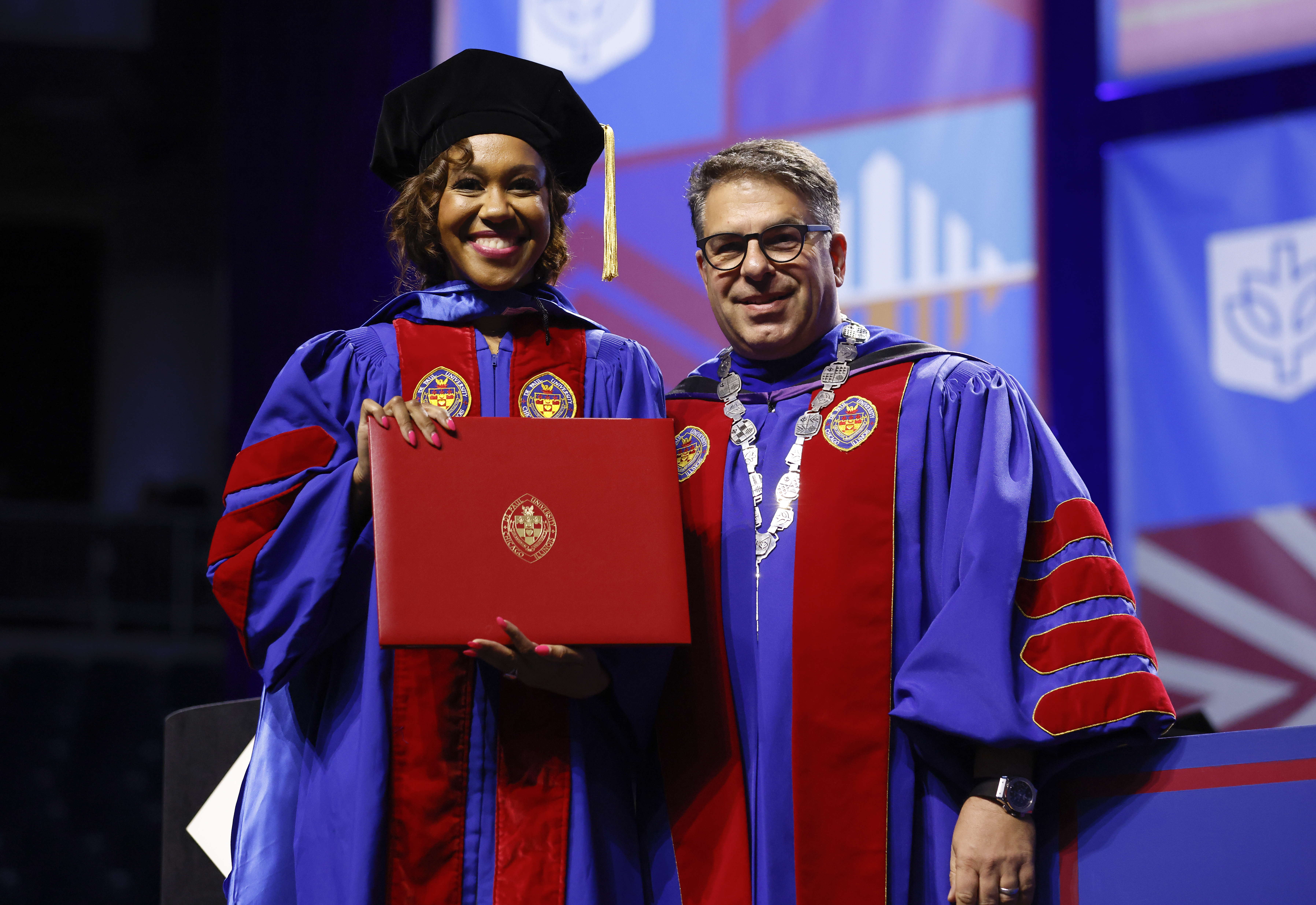 A man and woman in academic regalia