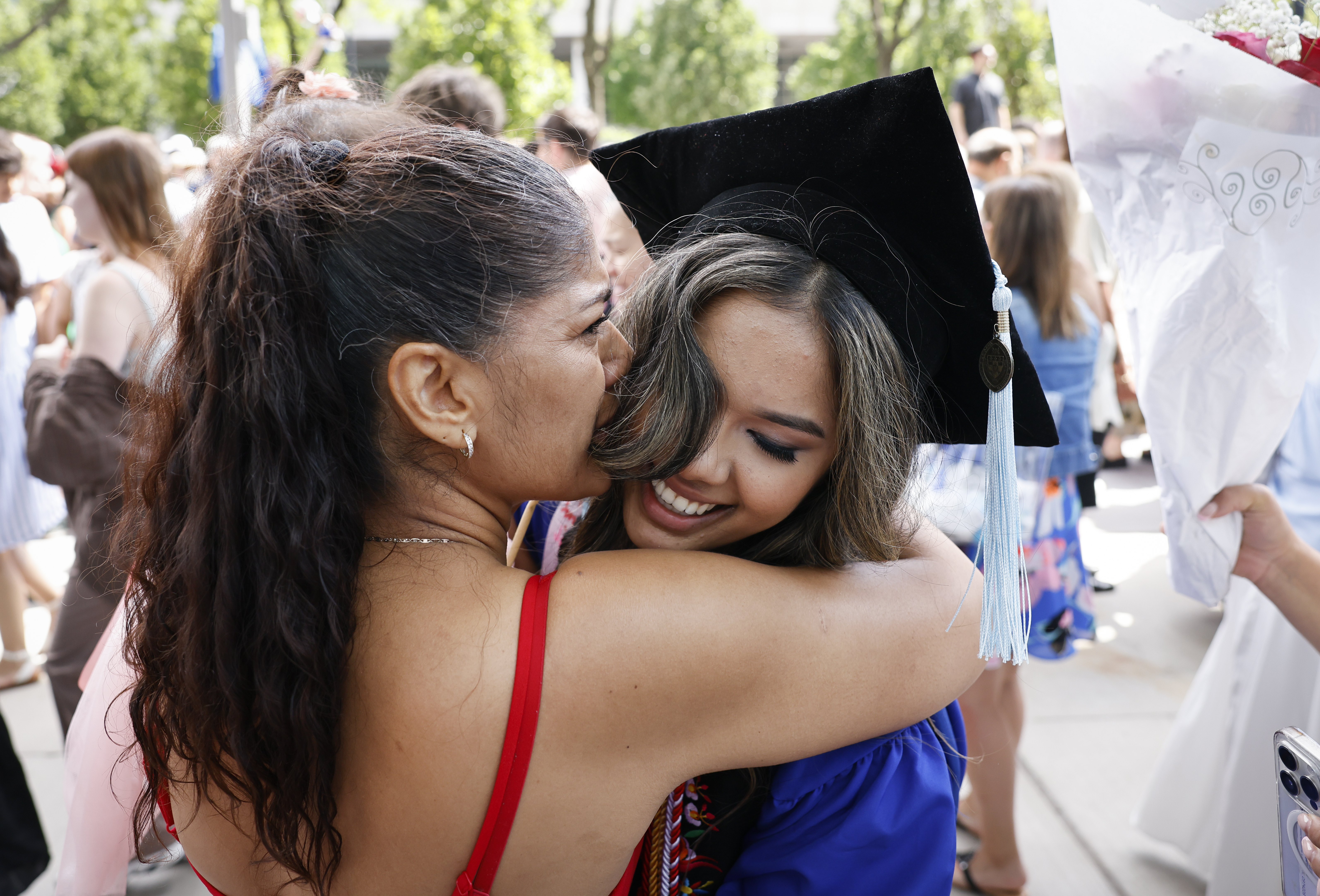 A woman hugging a graduate
