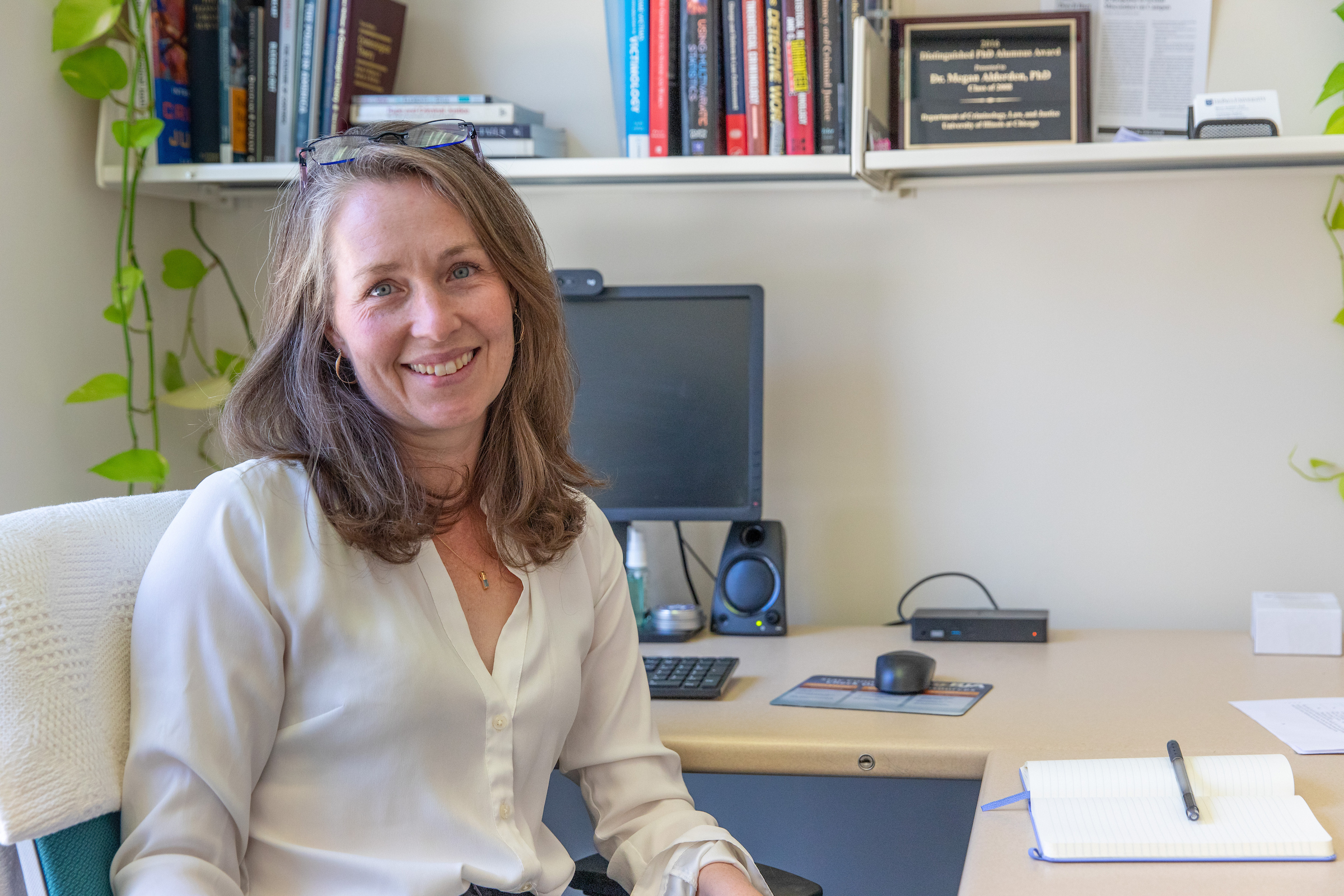 Megan Alderden sits in a chair in her office.