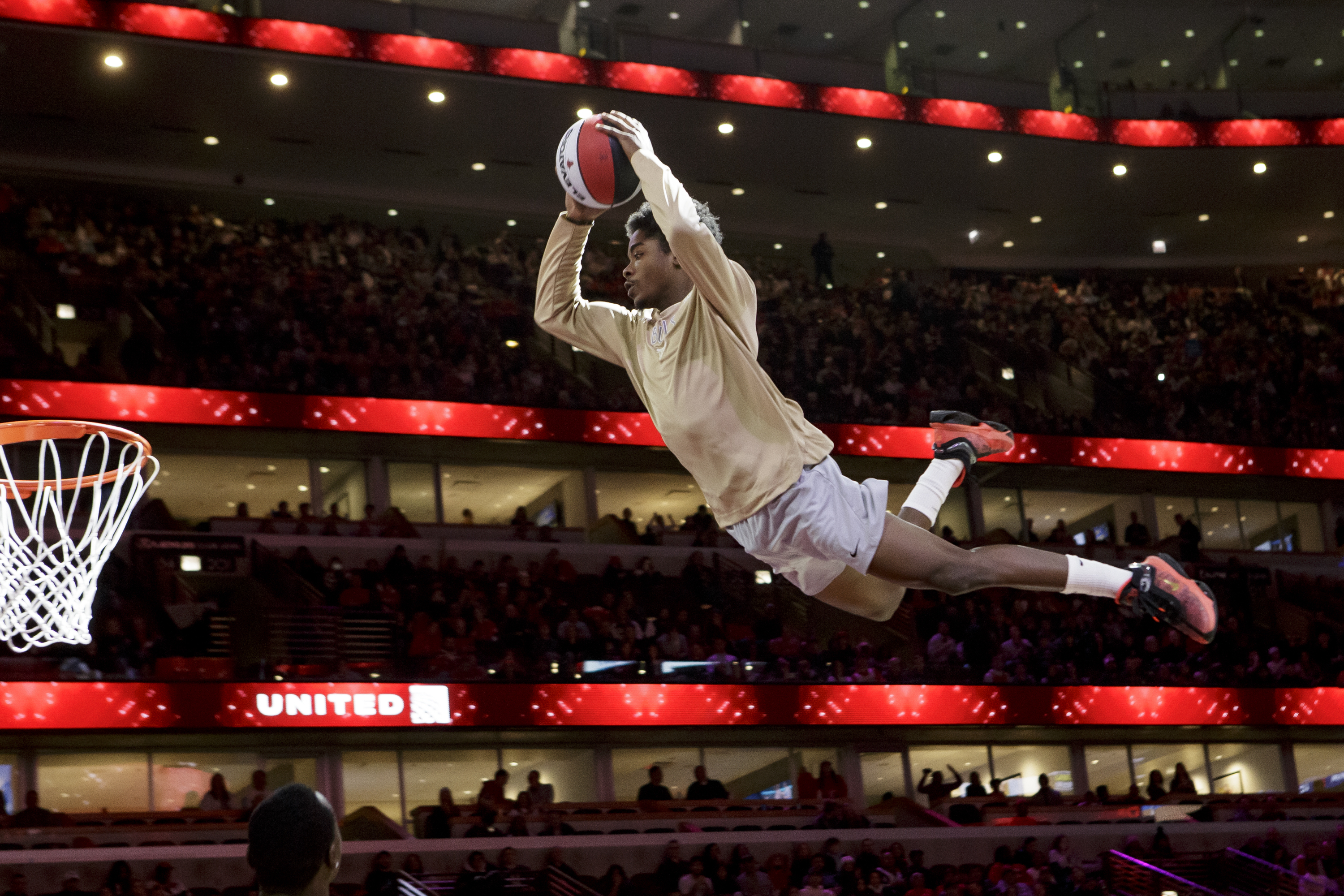 Jamari Grant soars through the air at a Chicago Bulls game as part of the Jesse White Tumblers.