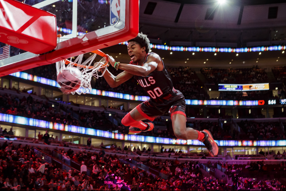 Jamari Grant slams the basketball through the hoop as part of the Jesse White Tumblers.