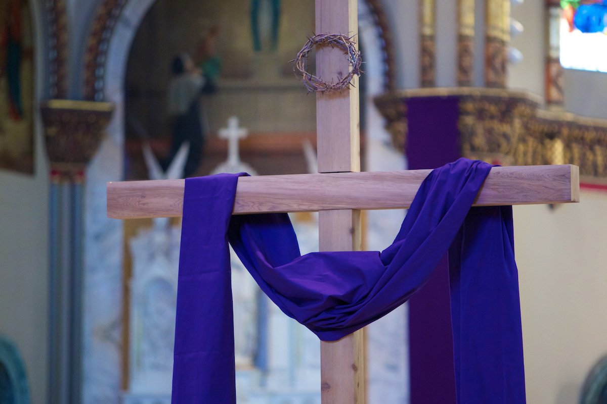 A cross draped in a purple linen stood in the center of St. Vincent de Paul parish during the Ash Wednesday mass. 