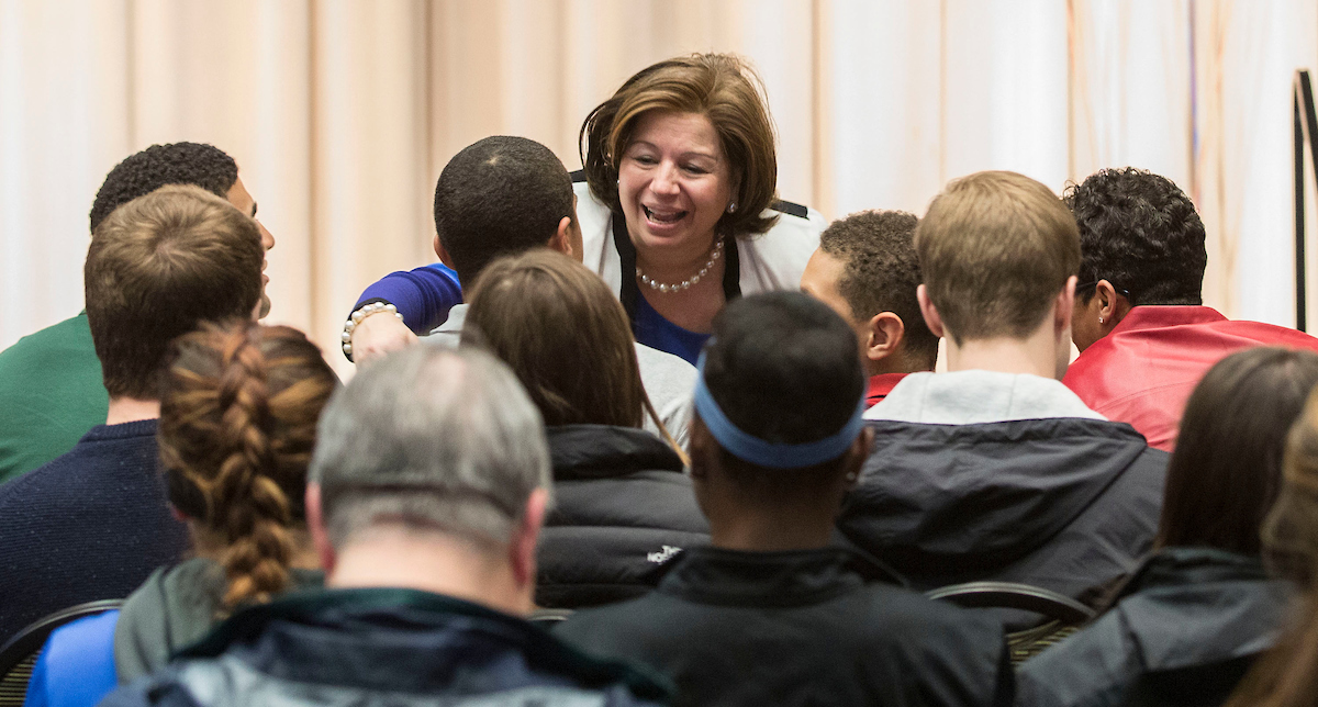 DePaul Athletics director Jean Lenti Ponsetto greets men’s basketball coach Dave Leitao and his family at a press conference in 2015. Today, June 5, Ponsetto has announced her retirement from the university. (DePaul University/Jamie Moncrief)