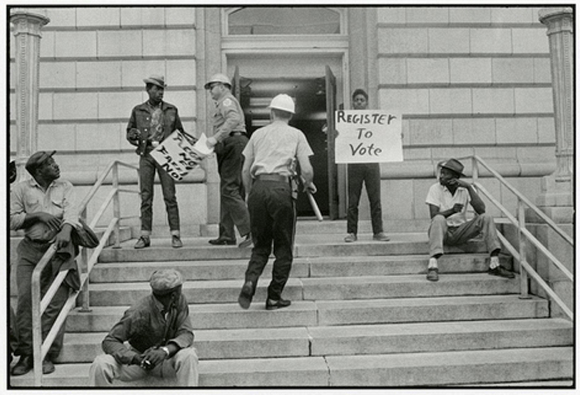 Danny Lyon, Sherriff Jim Clark arrests two demonstrators who displayed placards on the steps of the federal building in Selma, 1963. Courtesy of Thomas J. Wilson and Jill M. Garling.