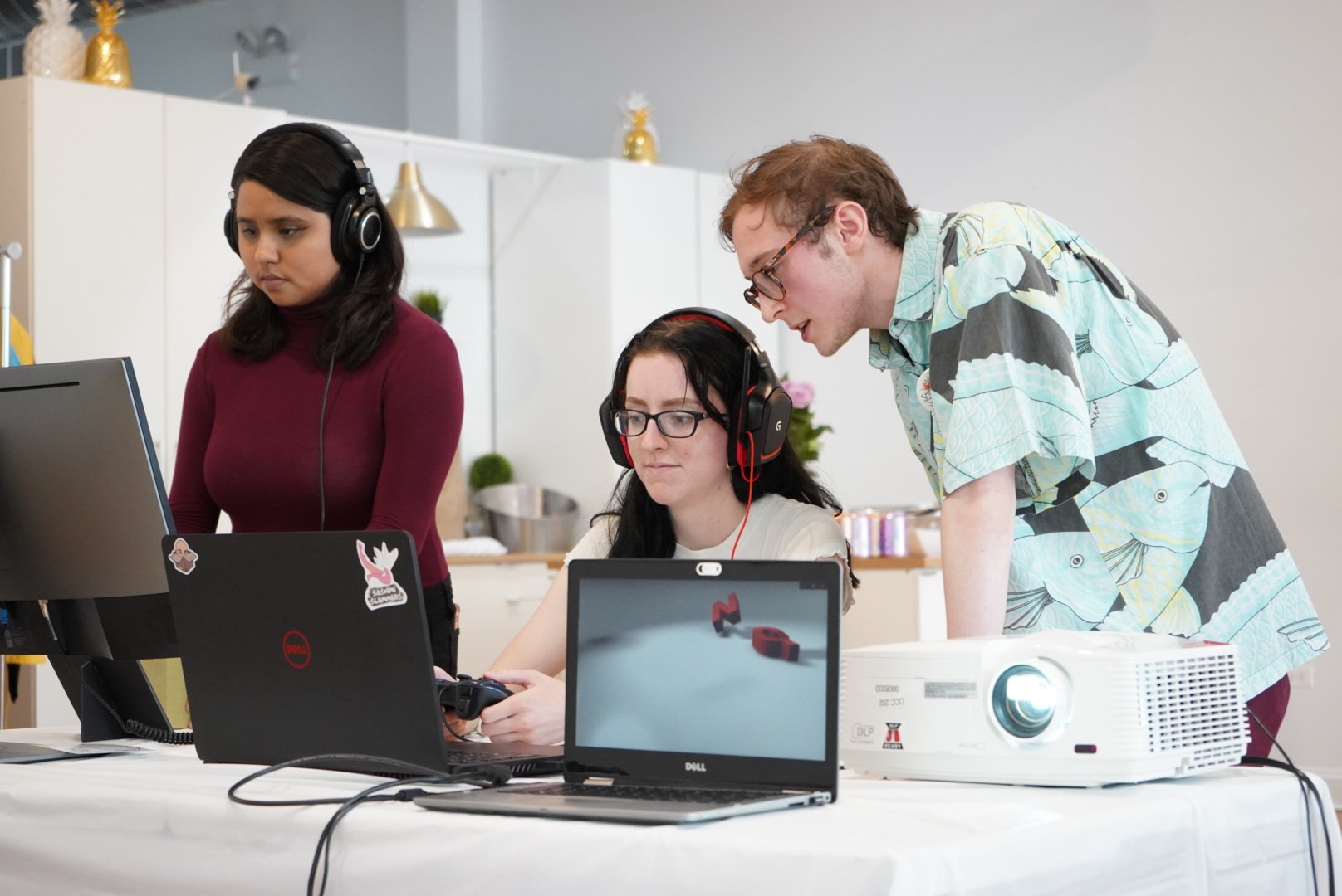 Three students work at computers