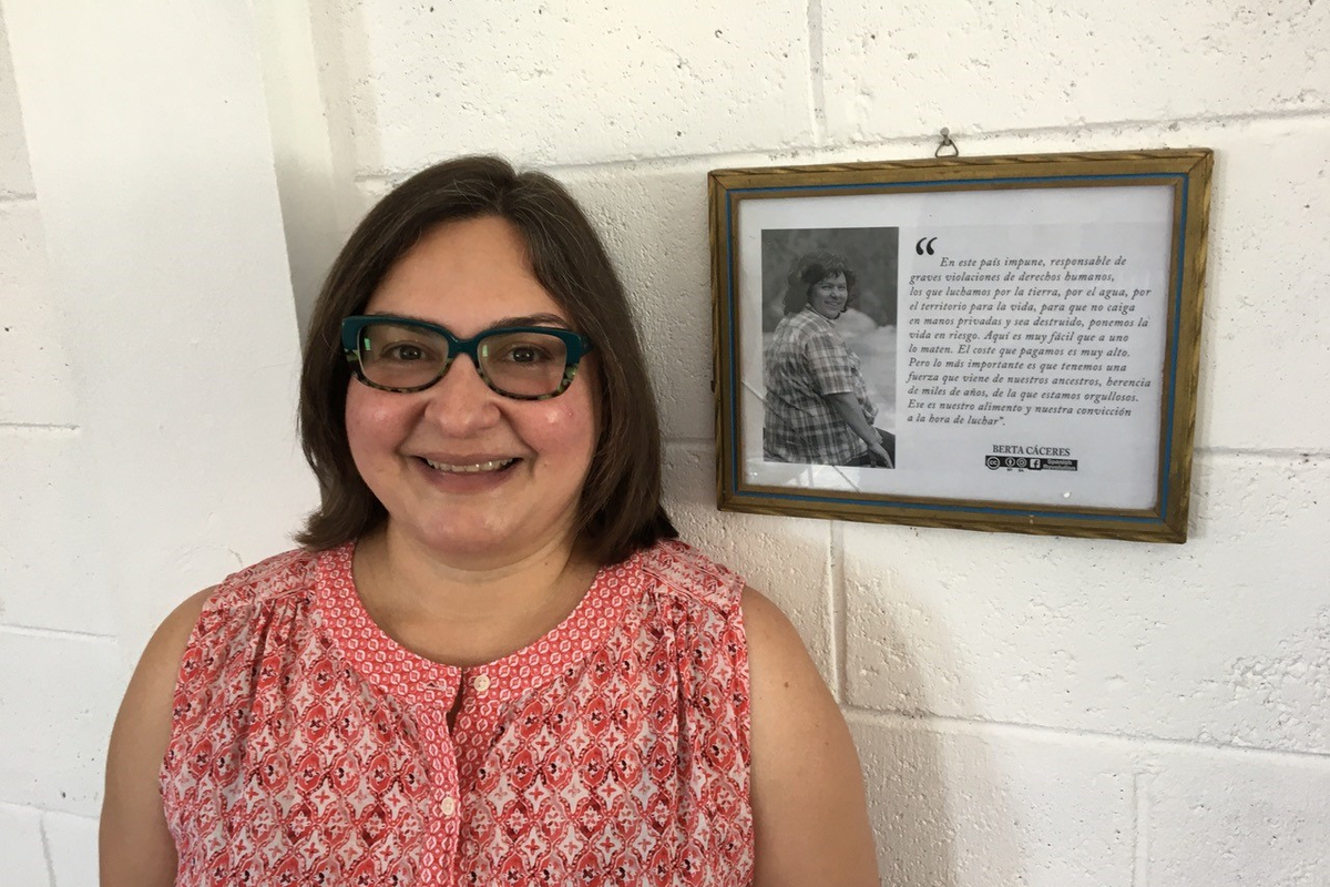 Susana Martínez standing by a framed photo of Berta Cáceres