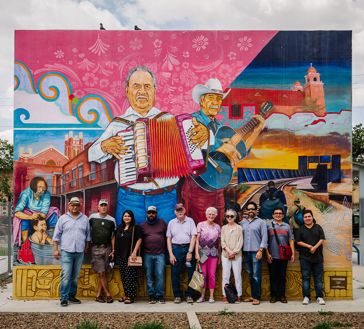 Christopher Tirres and colleagues from an educational Delegation pose in front of a mural by celebrated El Paso artist Jesús “Cimi” Alvarado.