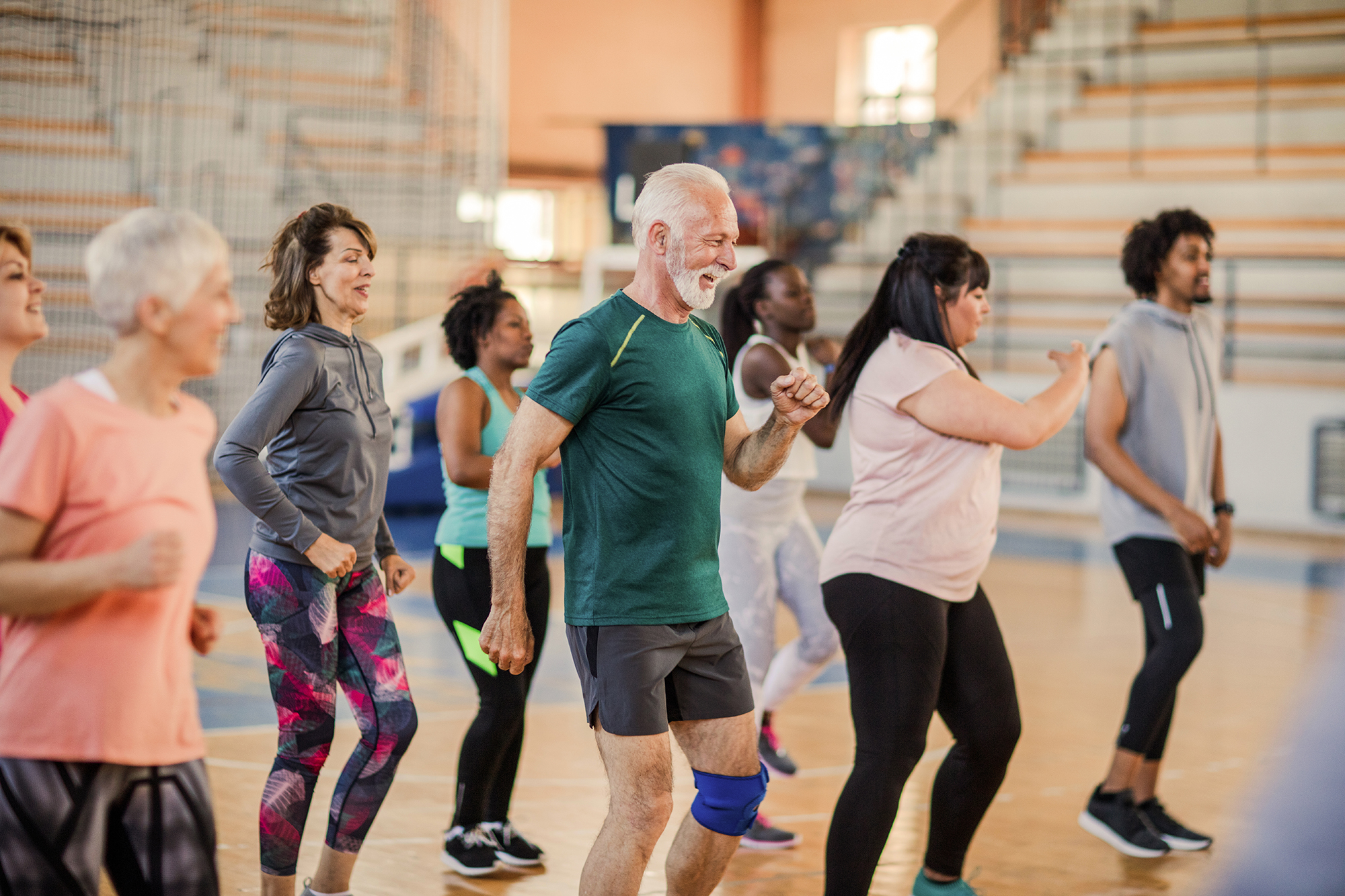 Group of adults of different ages dancing in an exercise class