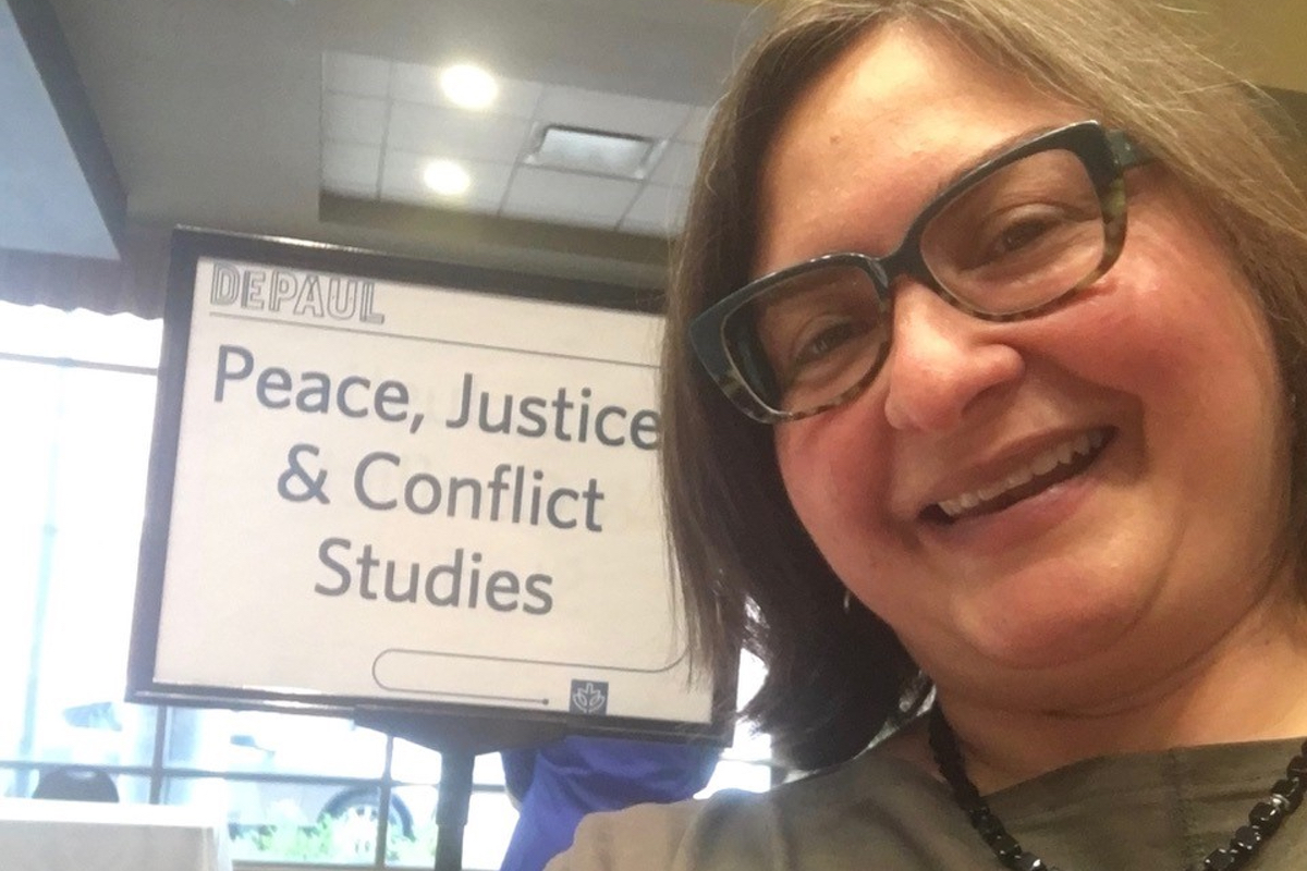 Susana Martínez standing in front of a sign reading Peace, Justice and Conflict Studies