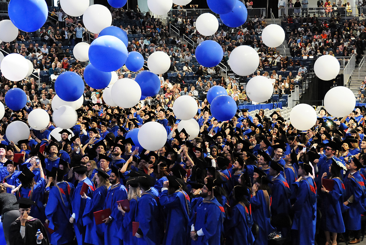 Blue and white balloon drop at commencement ceremony