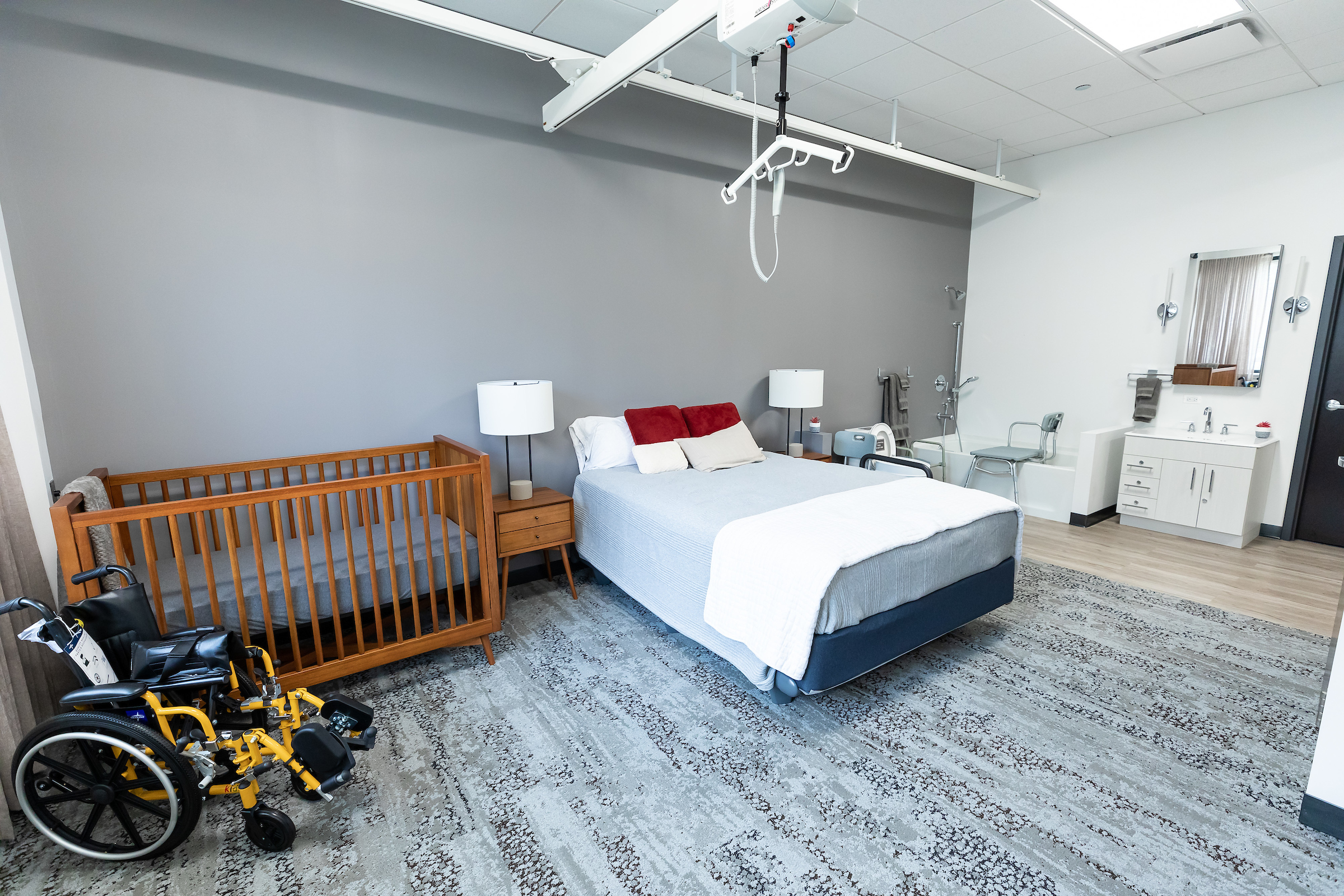 Occupational therapy apartment with bed, wheelchair, crib and bathroom
