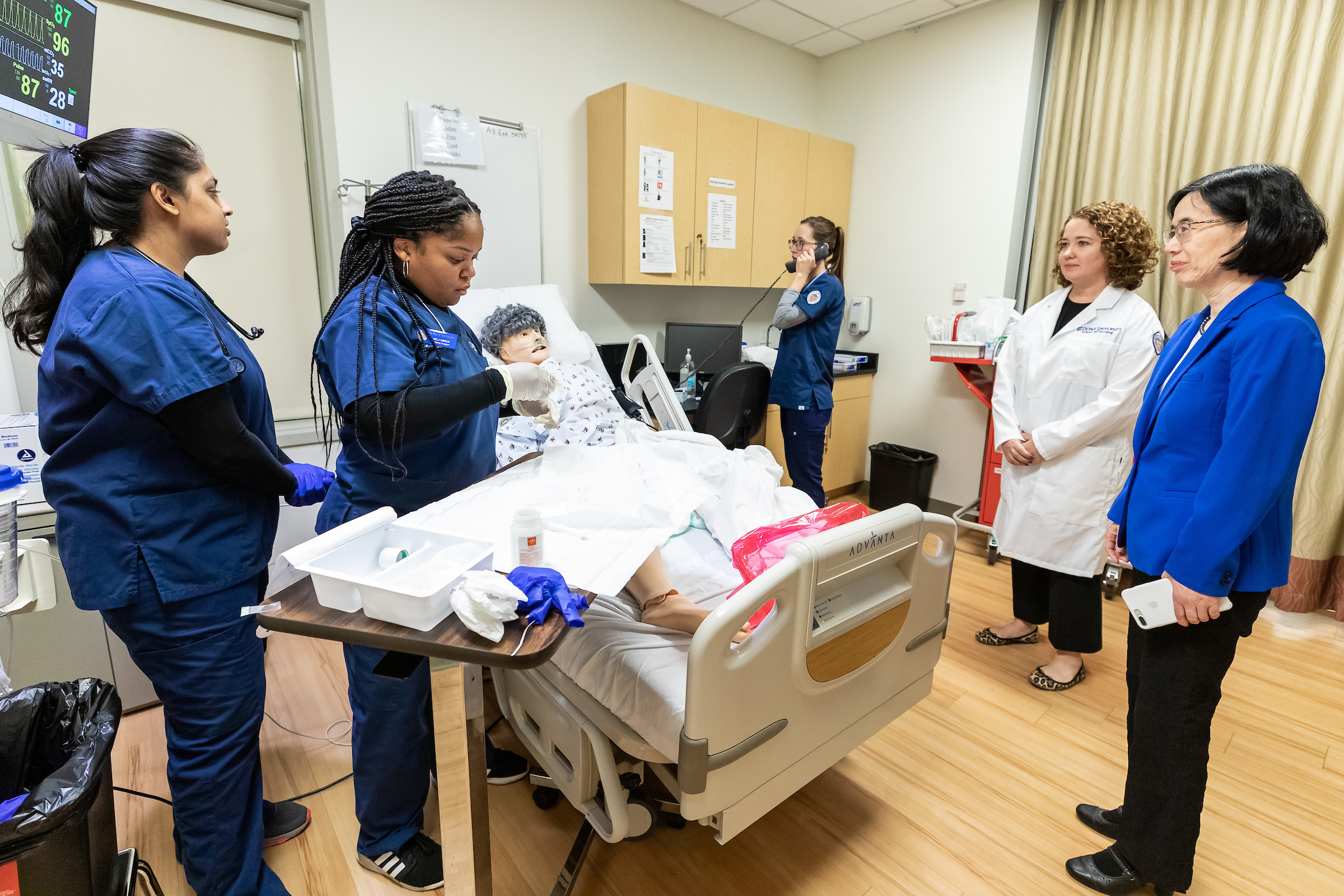 Student nurses work in a simulation lab at DePaul