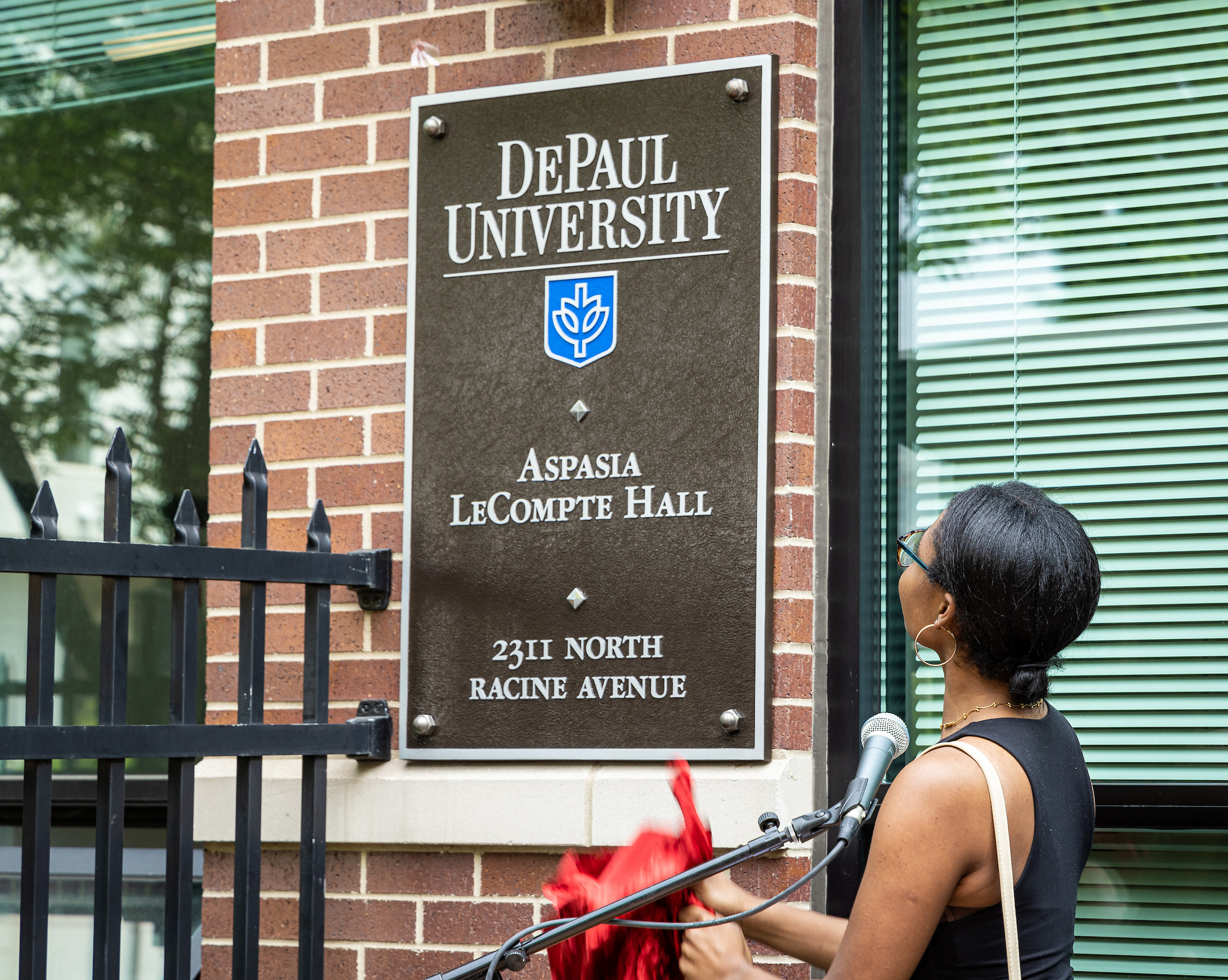 Sign is unveiled at Aspasia LeCompte residence hall. 