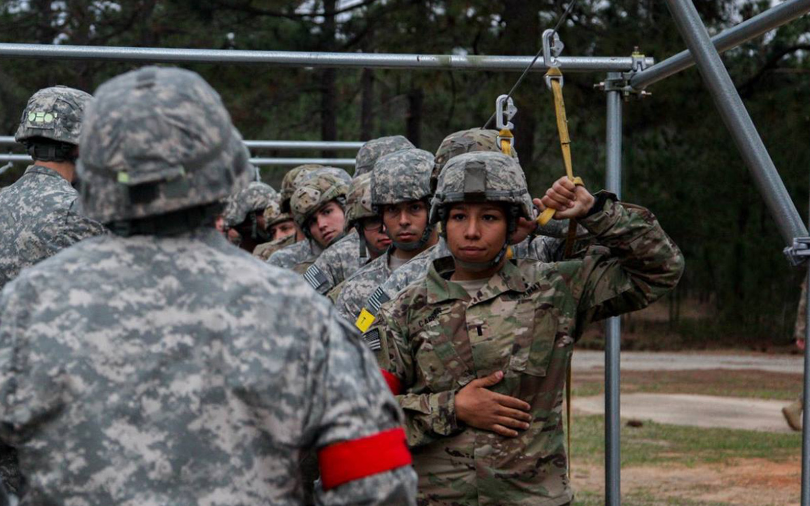 Keslie Carrion in army fatigues with a group of others during a training exercise