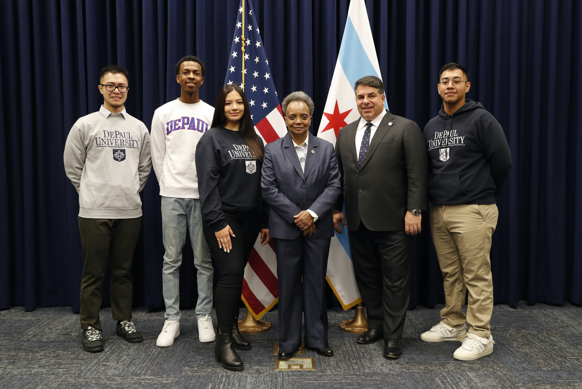 Rob Manuel, Lori Lightfoot and DePaul students stand shoulder to shoulder.