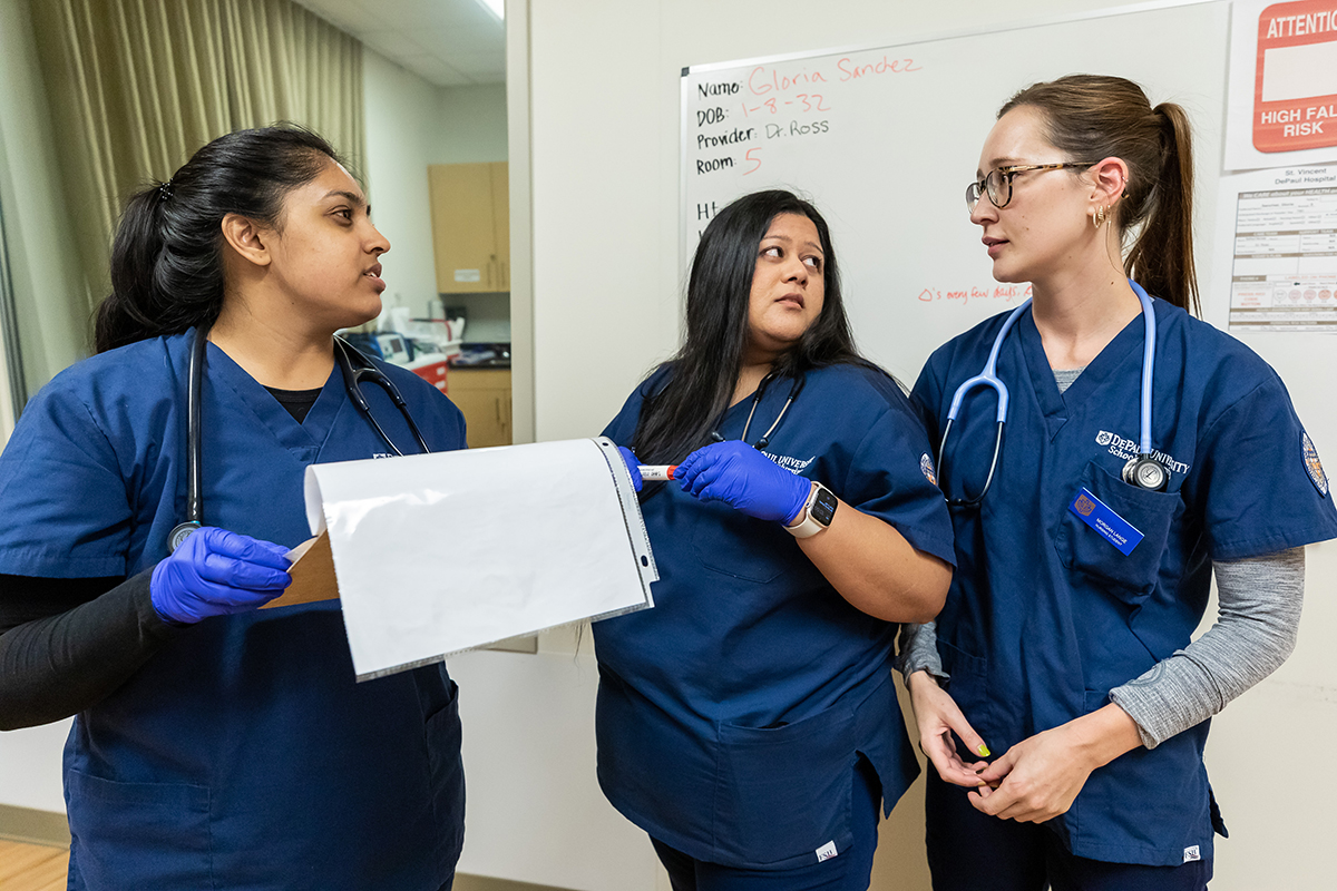 Nursing students confer about a patient