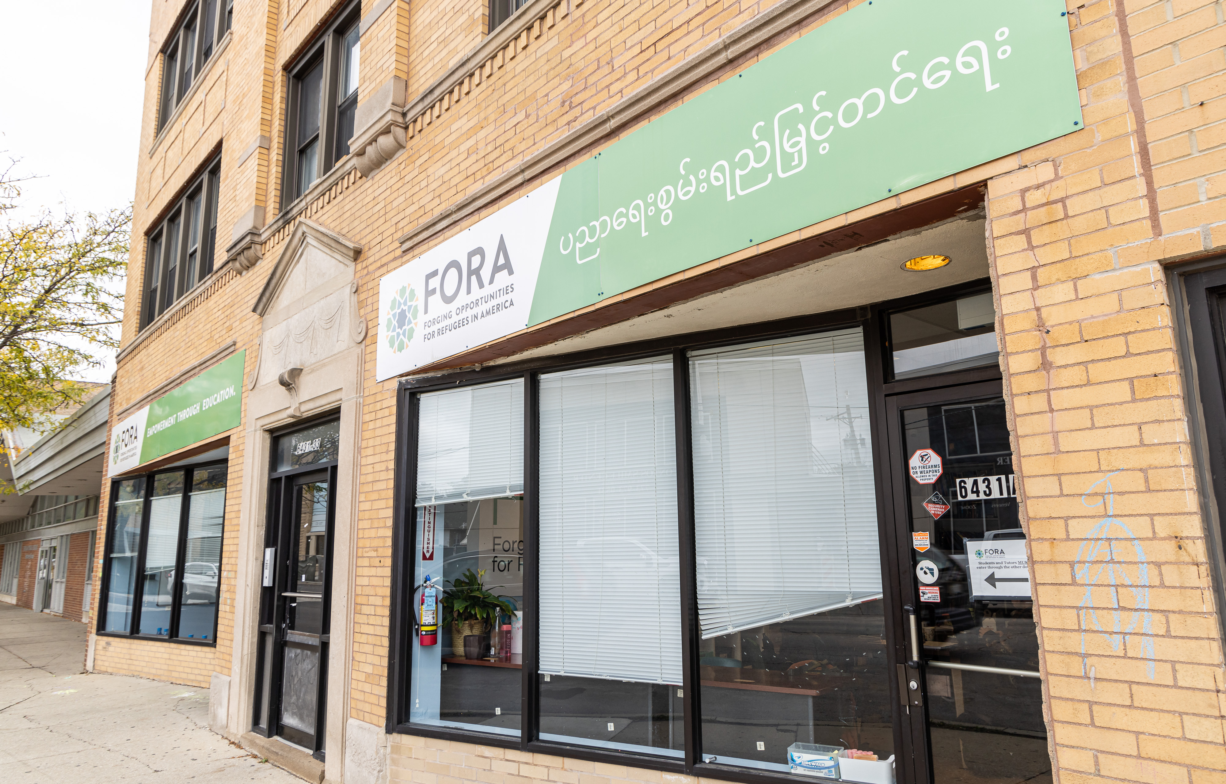 The outside of FORA's building in West Ridge, there is a green sign showing FORA's name and logo
