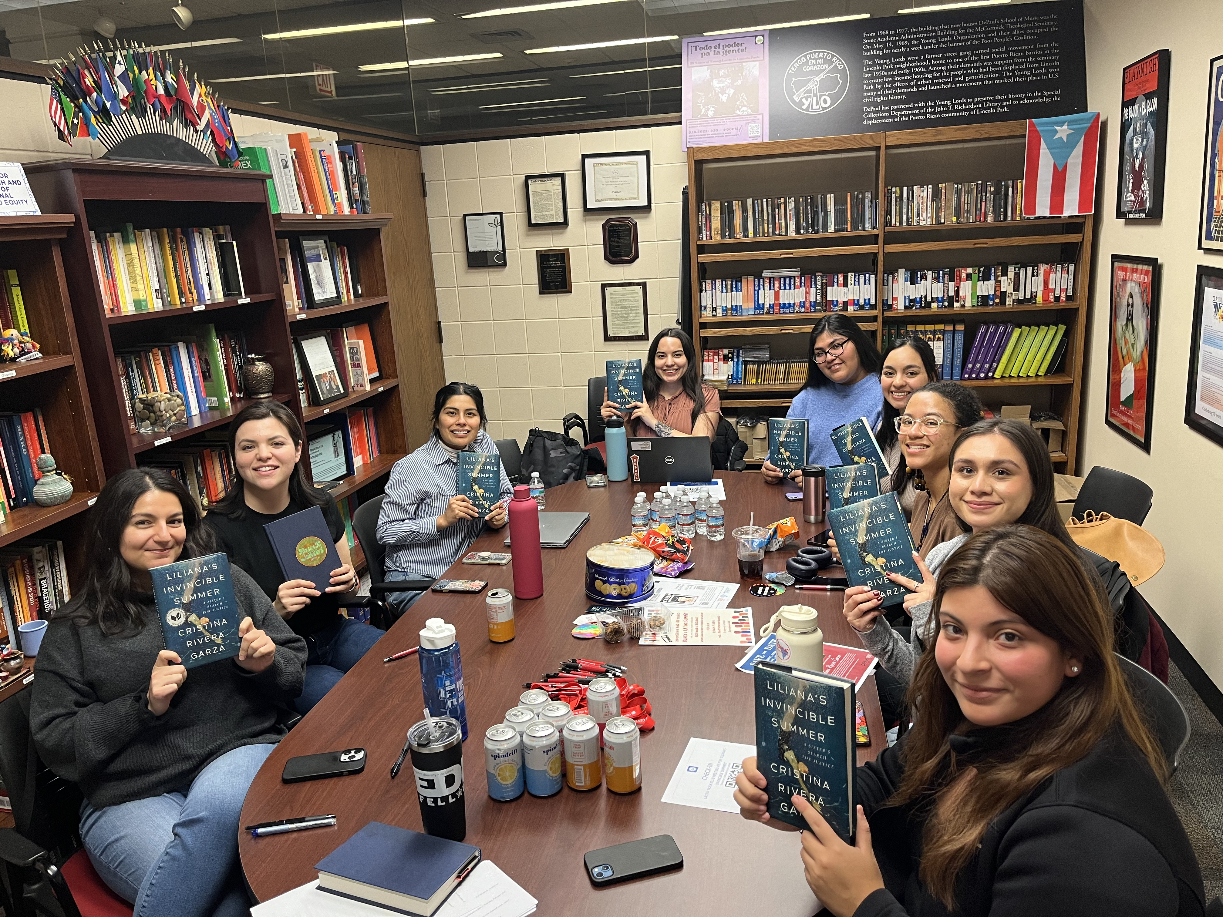 The Latinx Book club members holding up their books, Liliana's Invincible Summer, in DePaul's Center for Latino Research