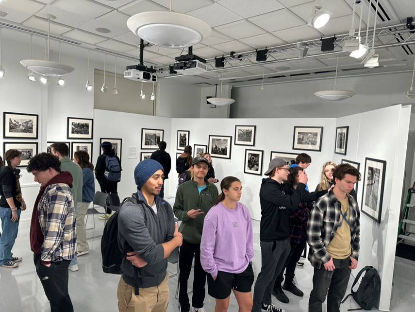 Many students looking at the pictures at the exhibit