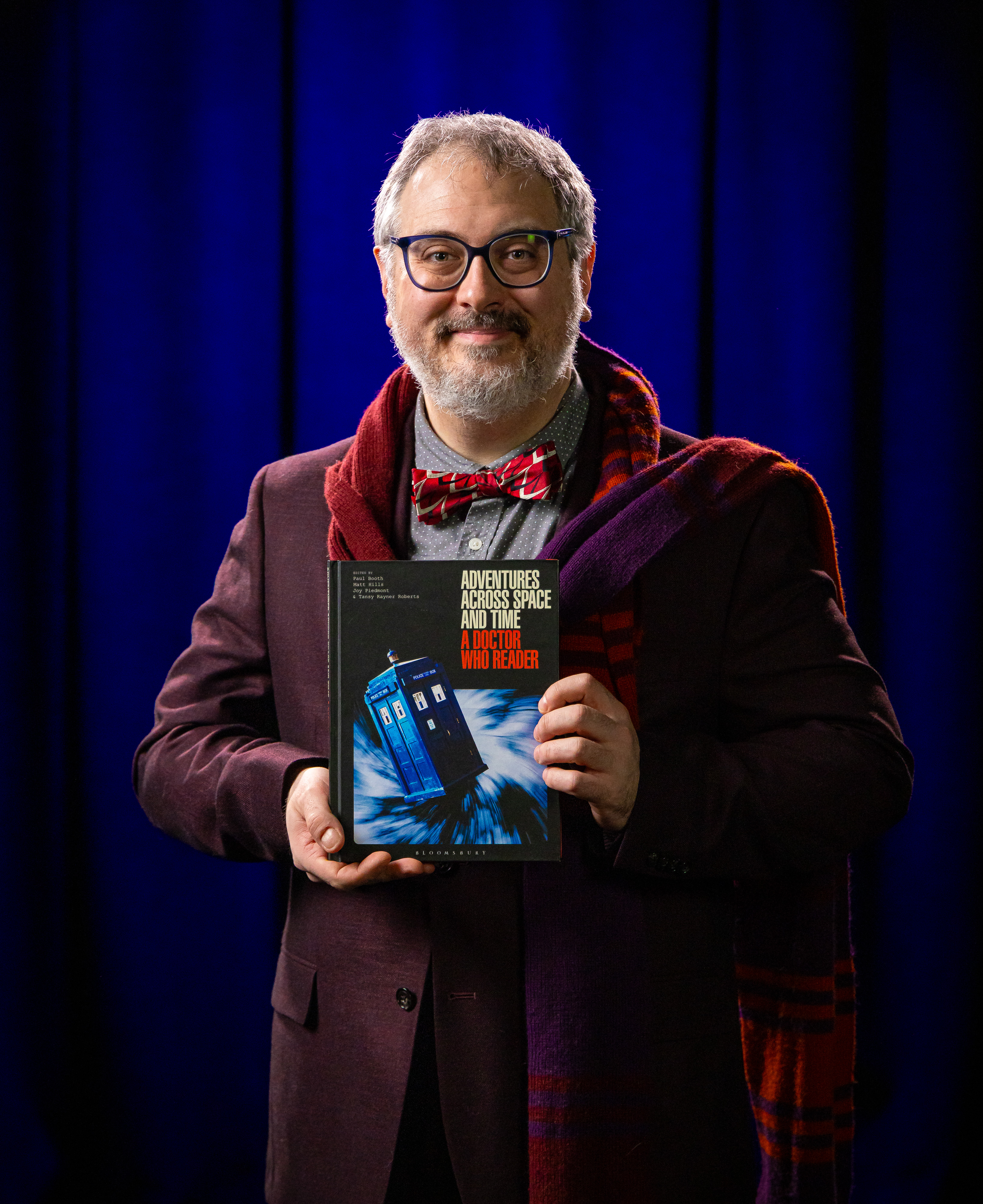 Paul Booth holding his book, 