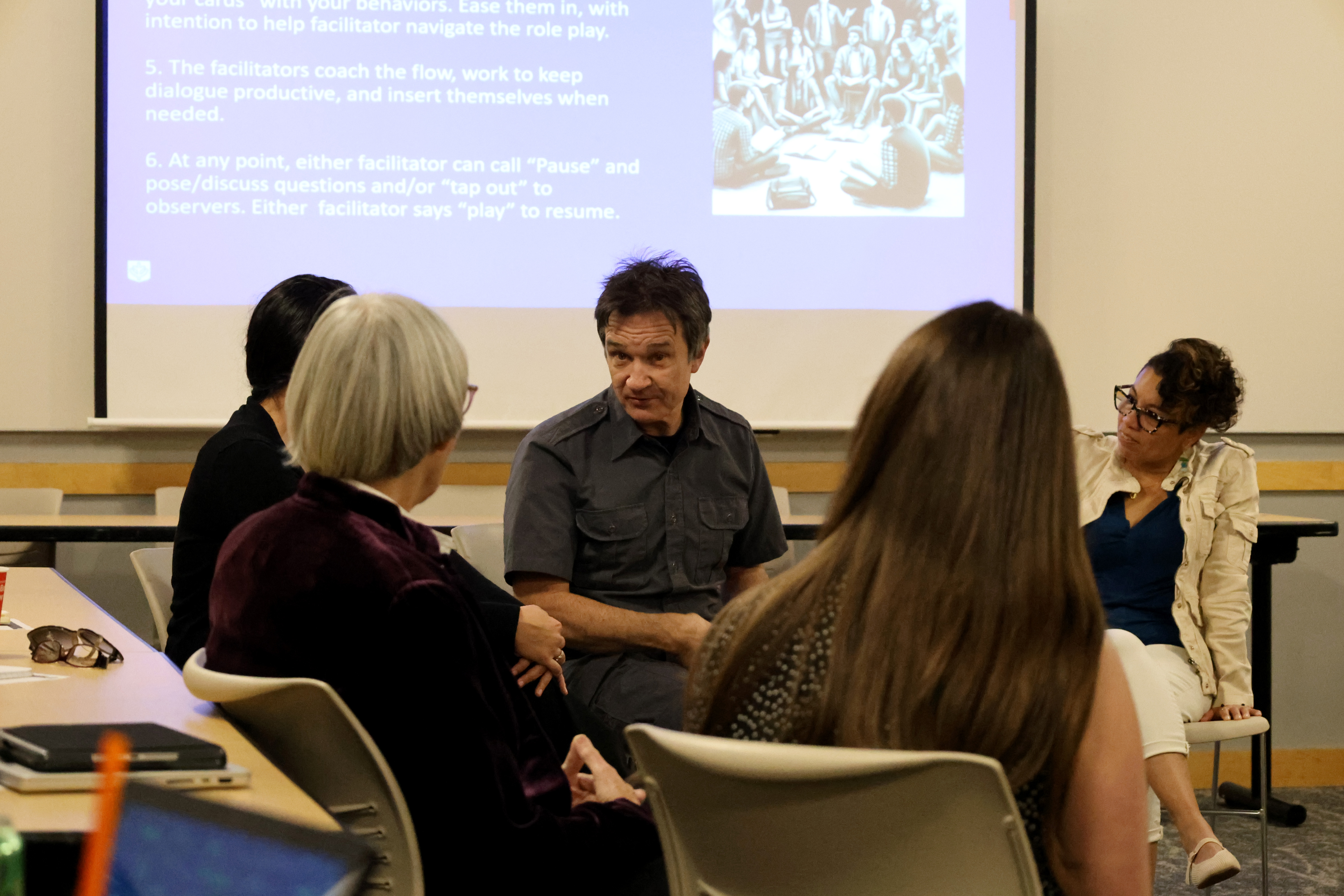 A group of four people in conversation.