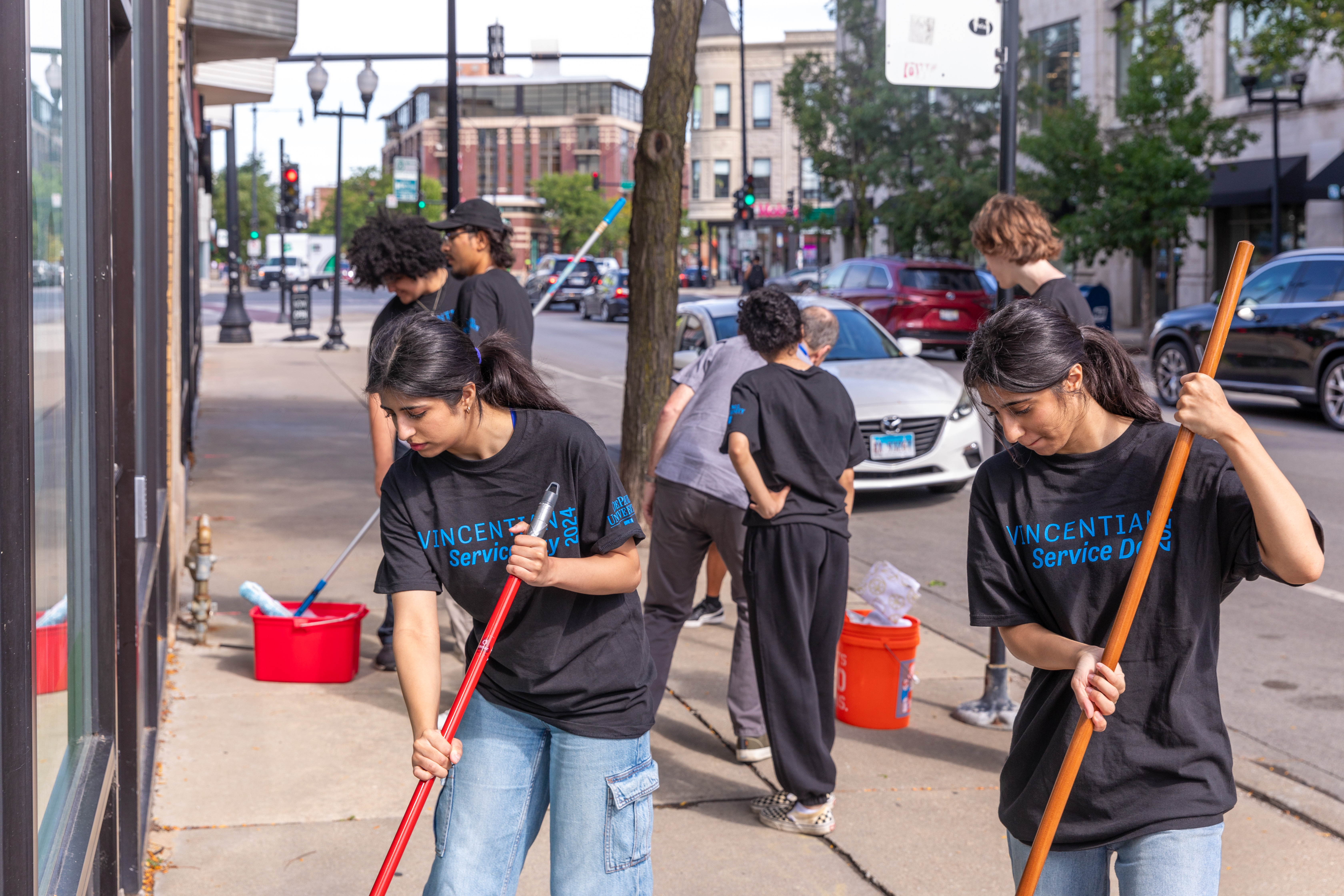 Students clean up a sidewalk