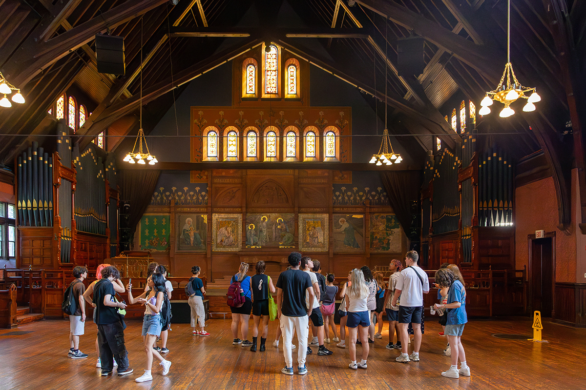 Students stand in front of religious art at Epiphany Center