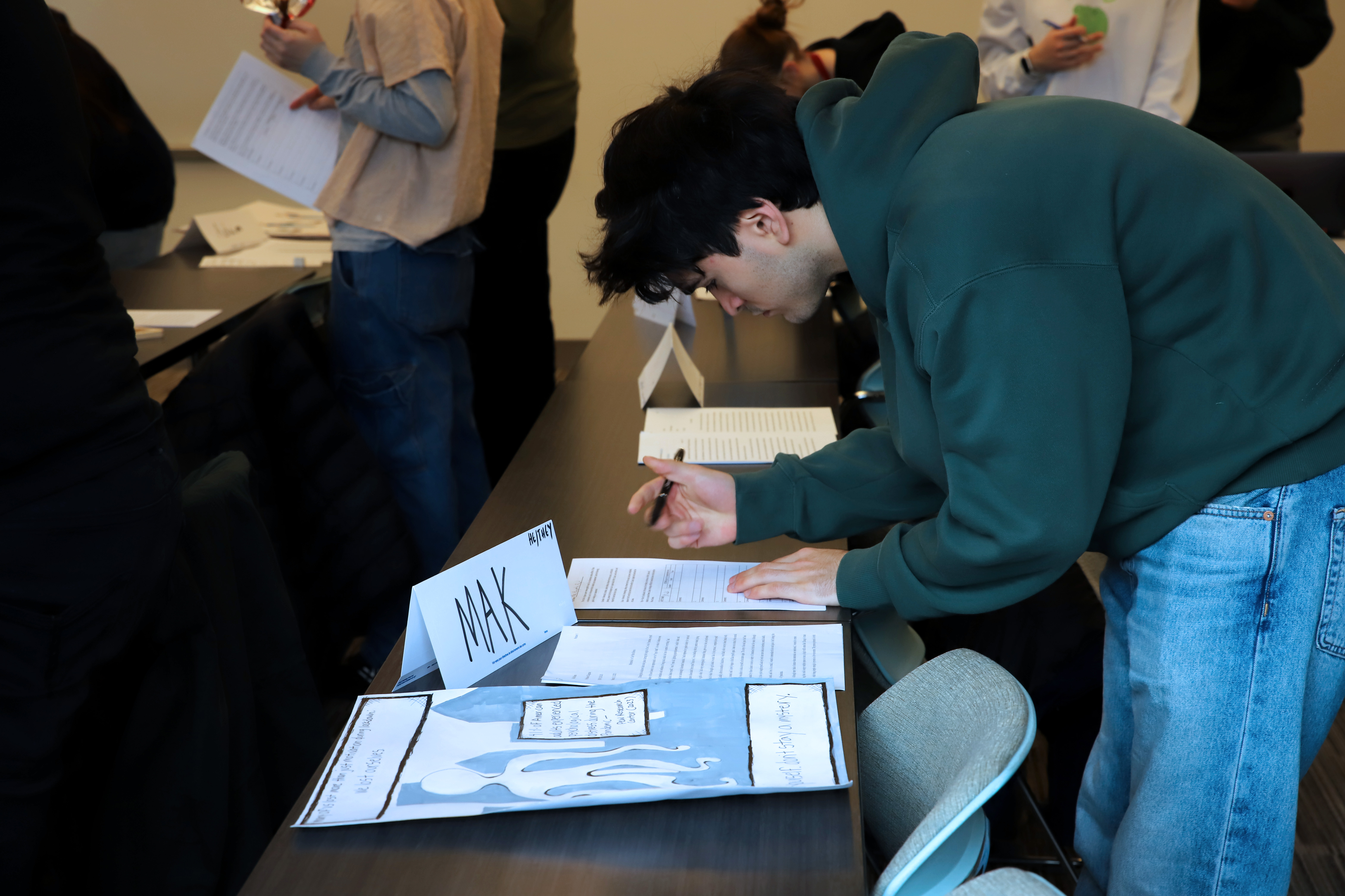 A student takes notes on a project