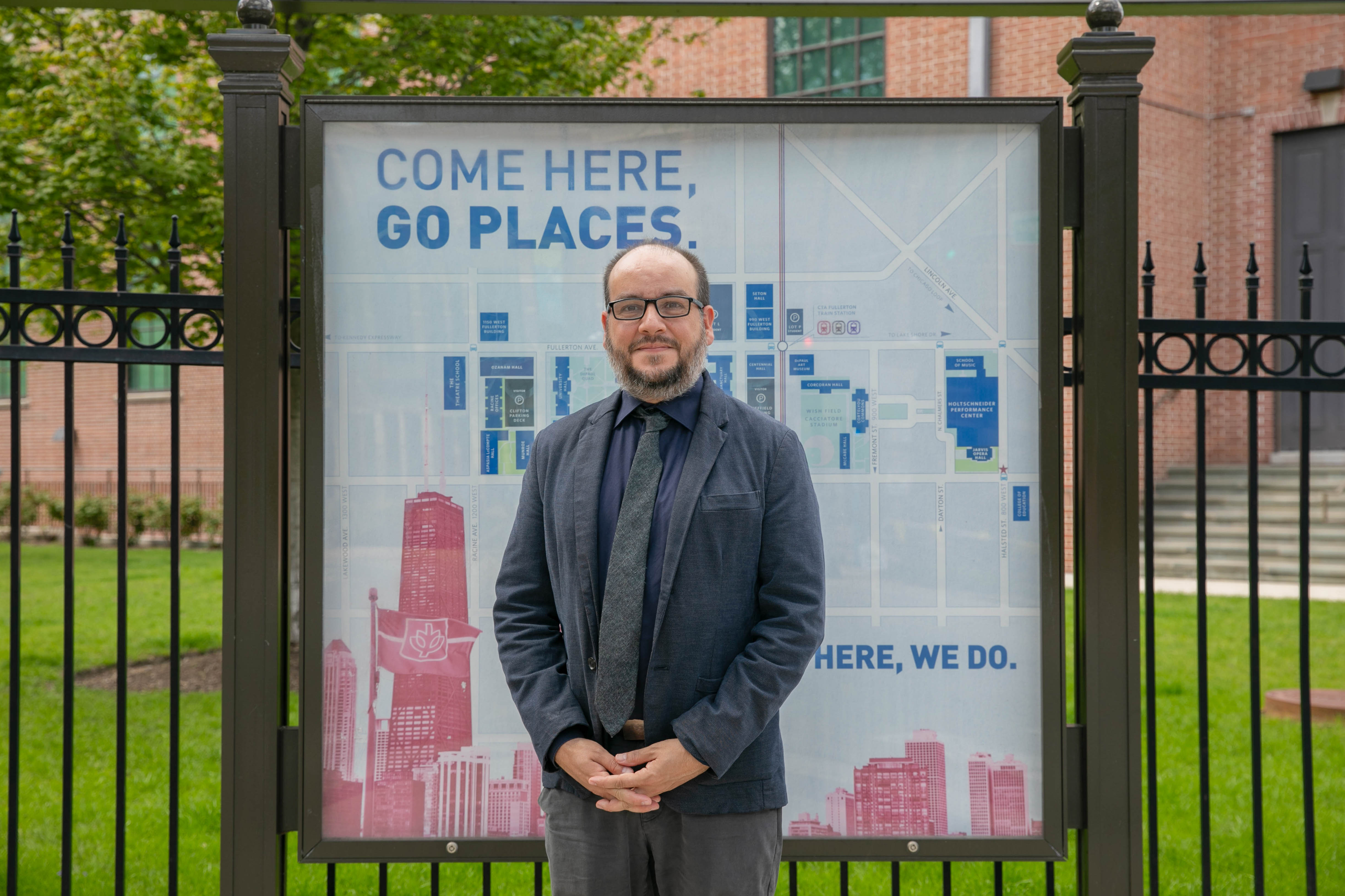 Fernando DeMaio in front of a DePaul sign Fernando DeMaio in front of a DePaul sign