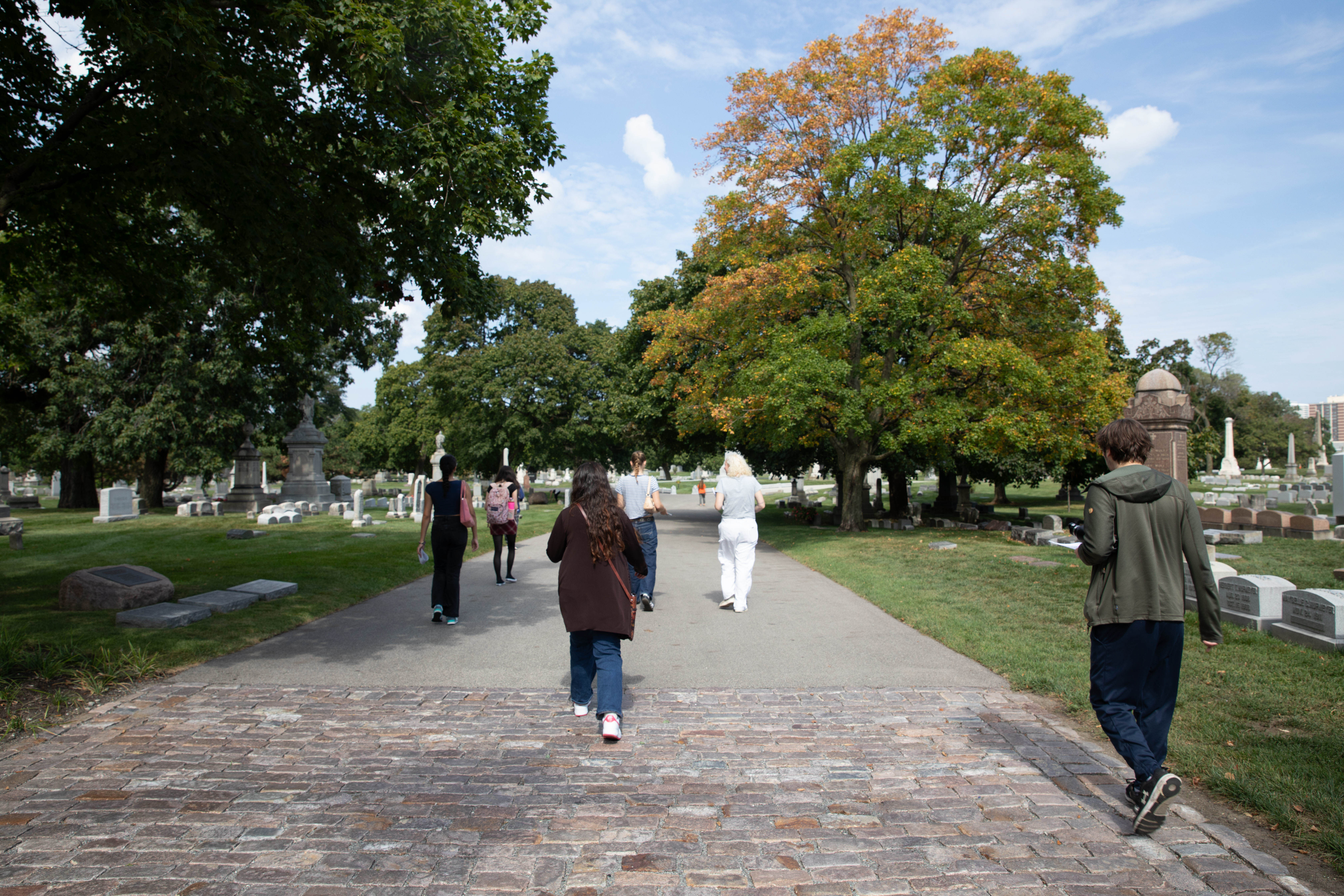 Students walking down a path in Graceland Cemetery