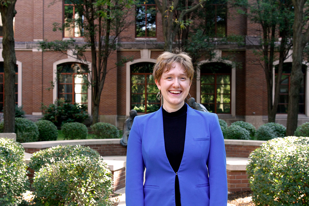 Photo of Kayla Schneider-Smith standing in front of buildings on DePaul's campus.