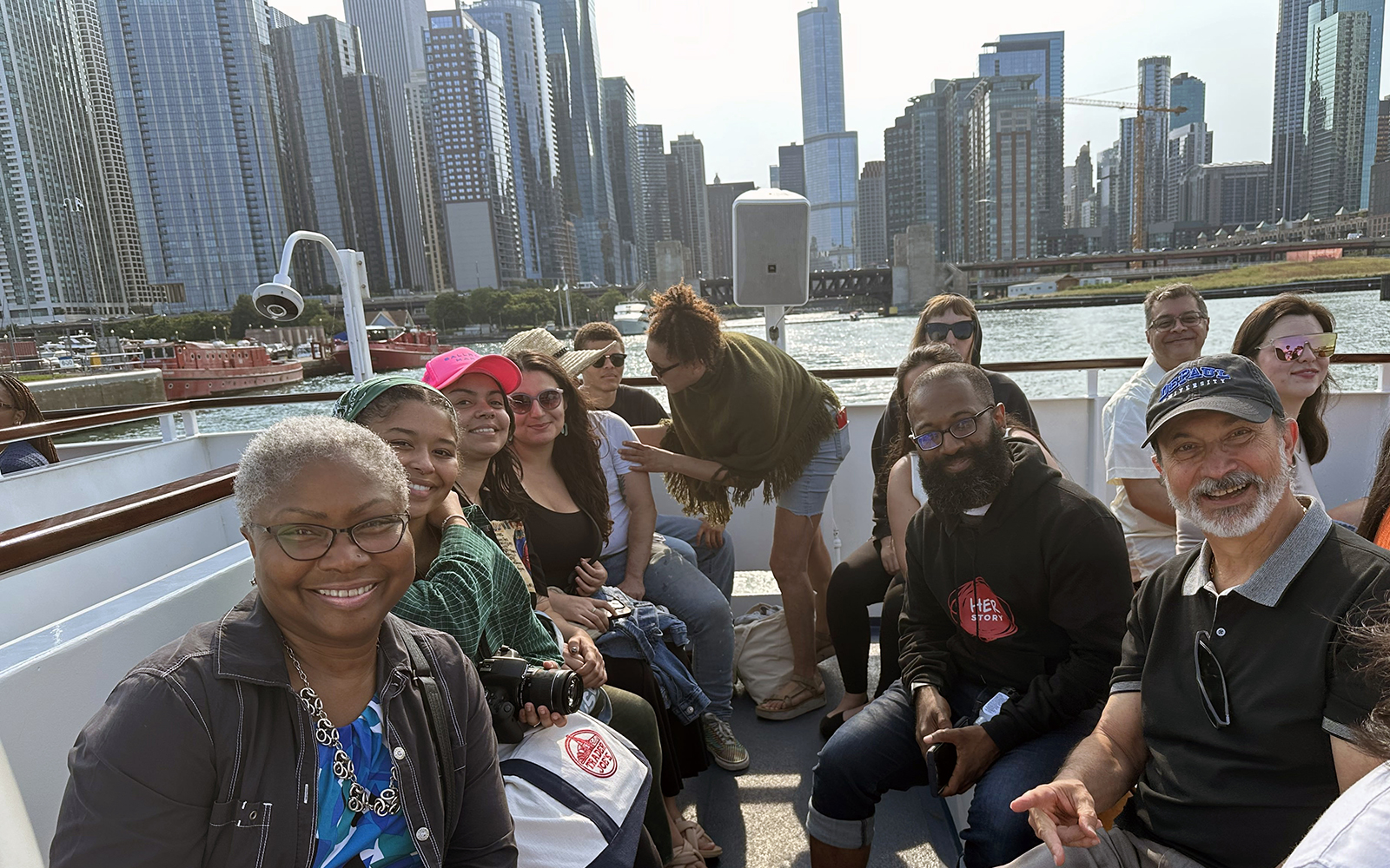 Members of the Social Transformation Research Collaborative's Summer Institute on a boat tour down the Chicago River. Pictured is Valerie Johnson, DePaul's associate provost for diversity, equity and inclusion, Guillermo Vásquez de Velasco, dean of DePaul's College of Liberal Arts and Social Sciences, and Taurean Webb, a Social Transformation Research Collaborative Post Doctoral Fellow.