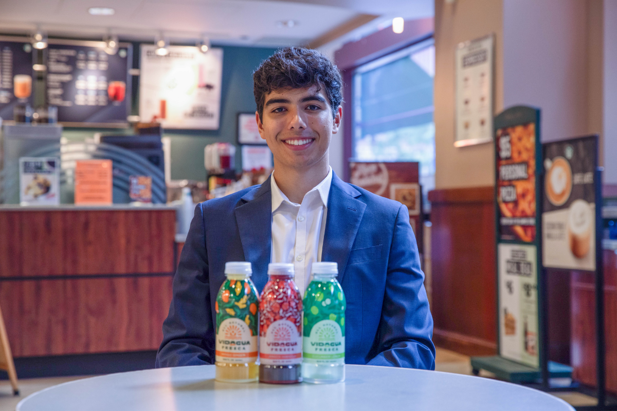Student sitting in front of three drinks Student sitting in front of three drinks