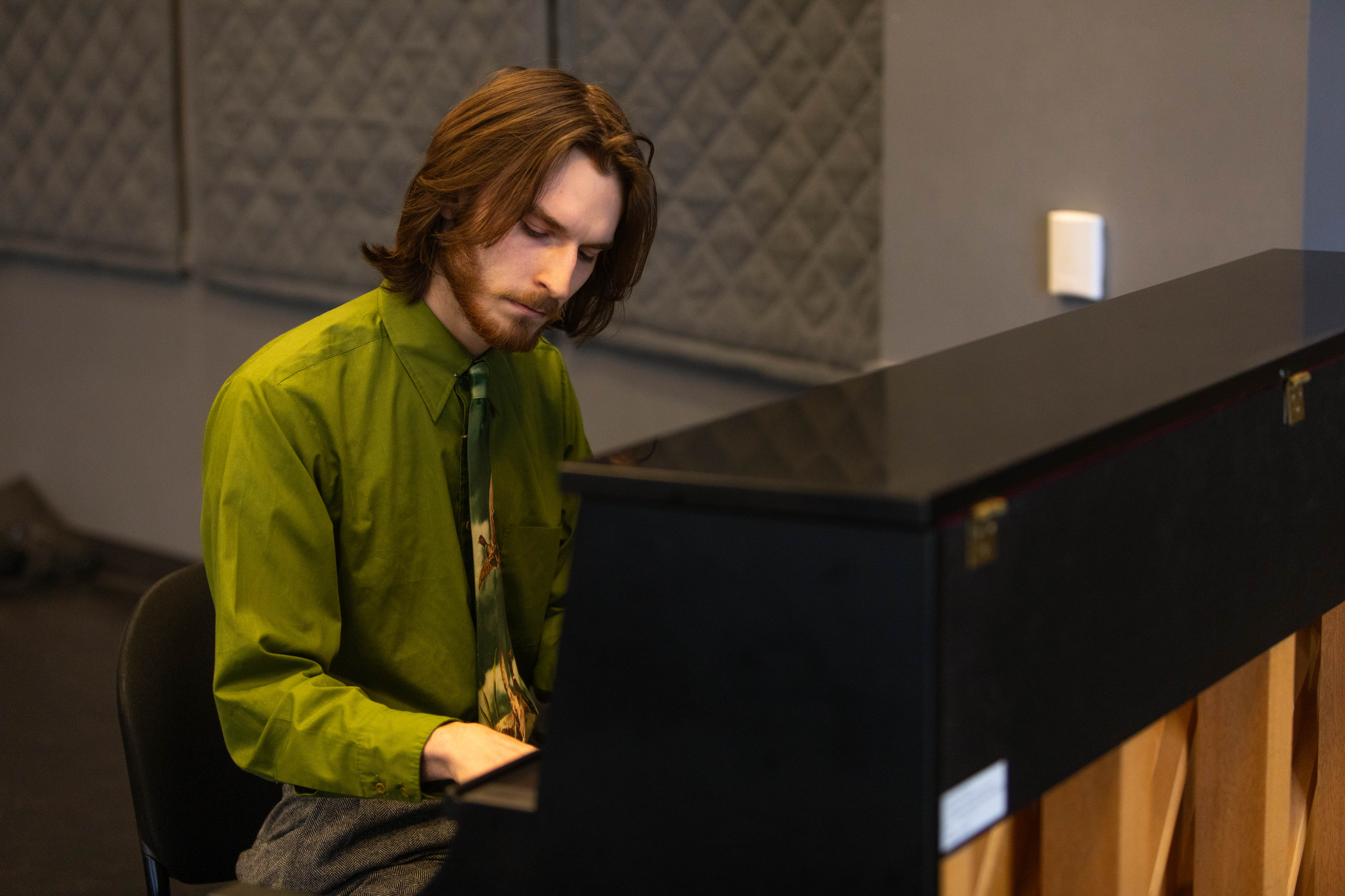Student Ethan Korvne plays the piano