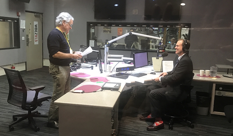 Professor Mark Johnston prepares for a radio interview with 