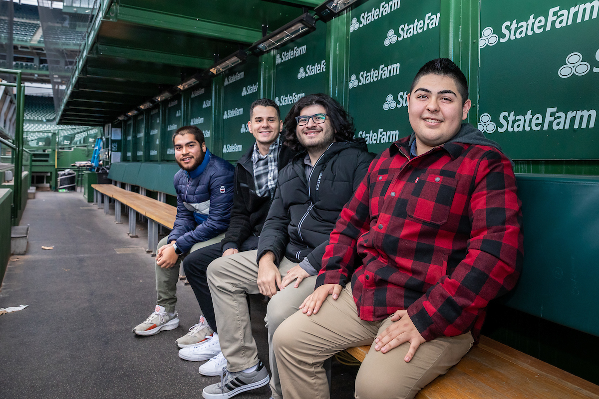 DePaul students sit in the dugout at Wrigley Field