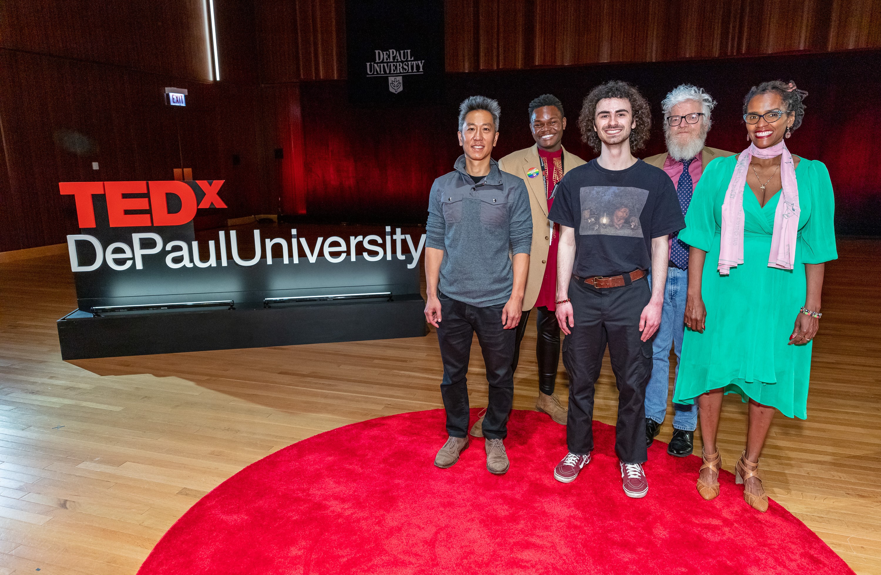 2022's five TEDx speakers stand on stage after the event