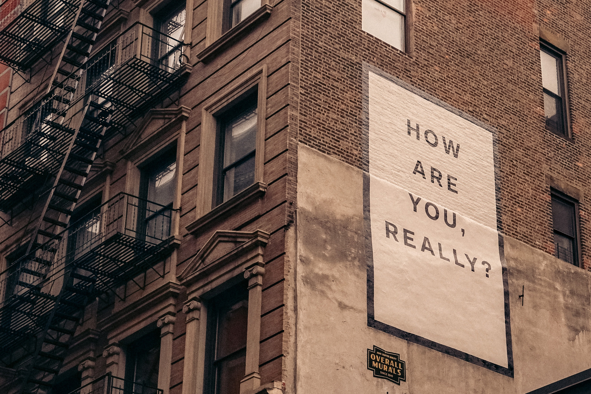 Sign on a building saying, How are you really?