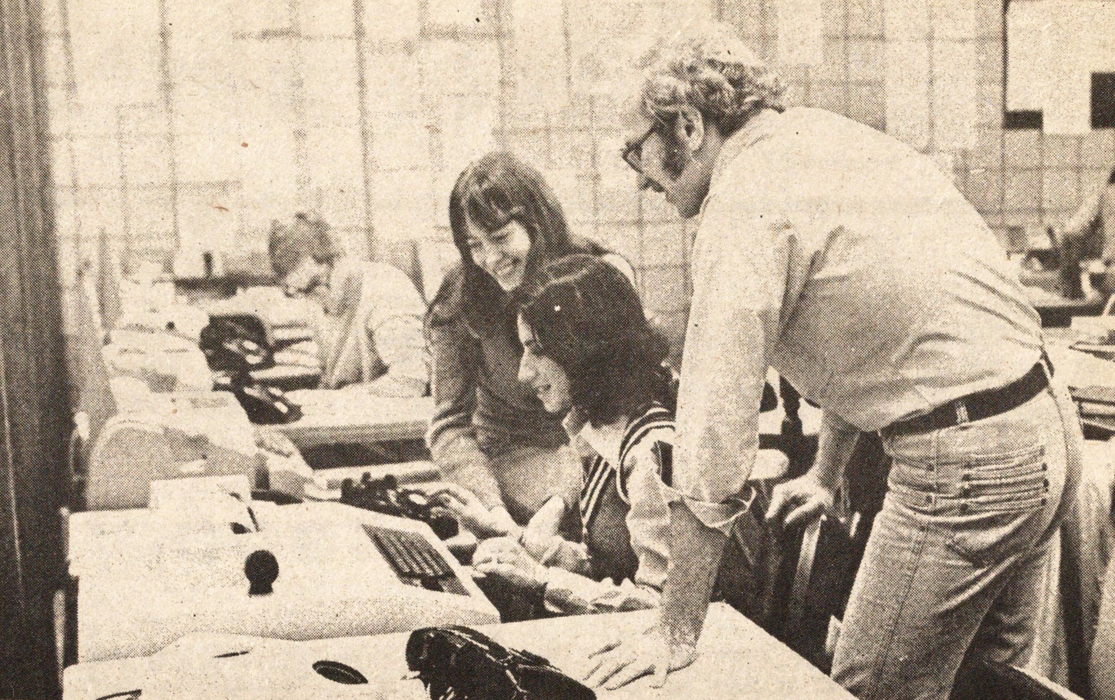Computer science students working with an instructor in the Uptown computer room, 1979